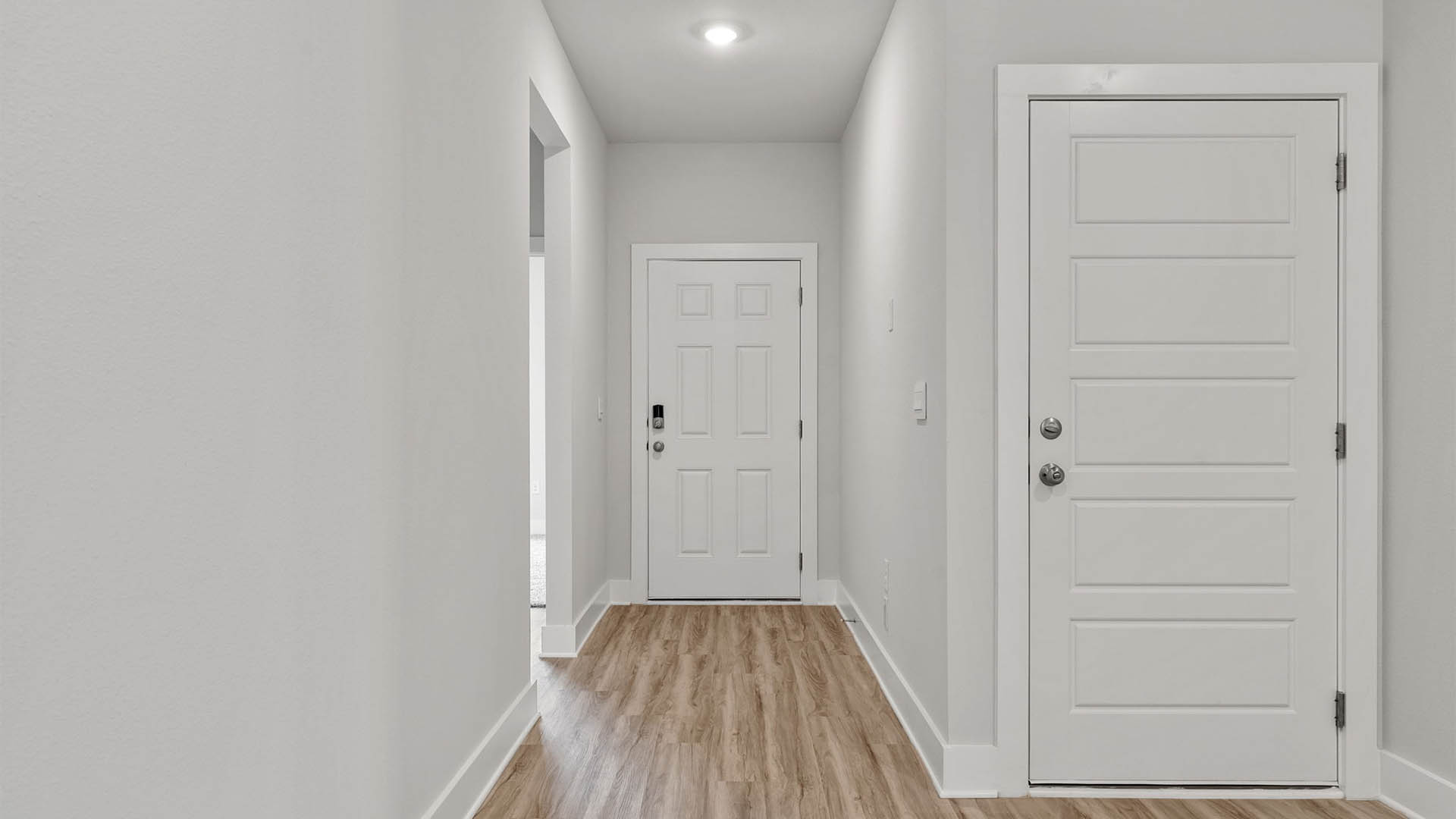 Front entrance with EVP flooring next to bedrooms and bathroom.