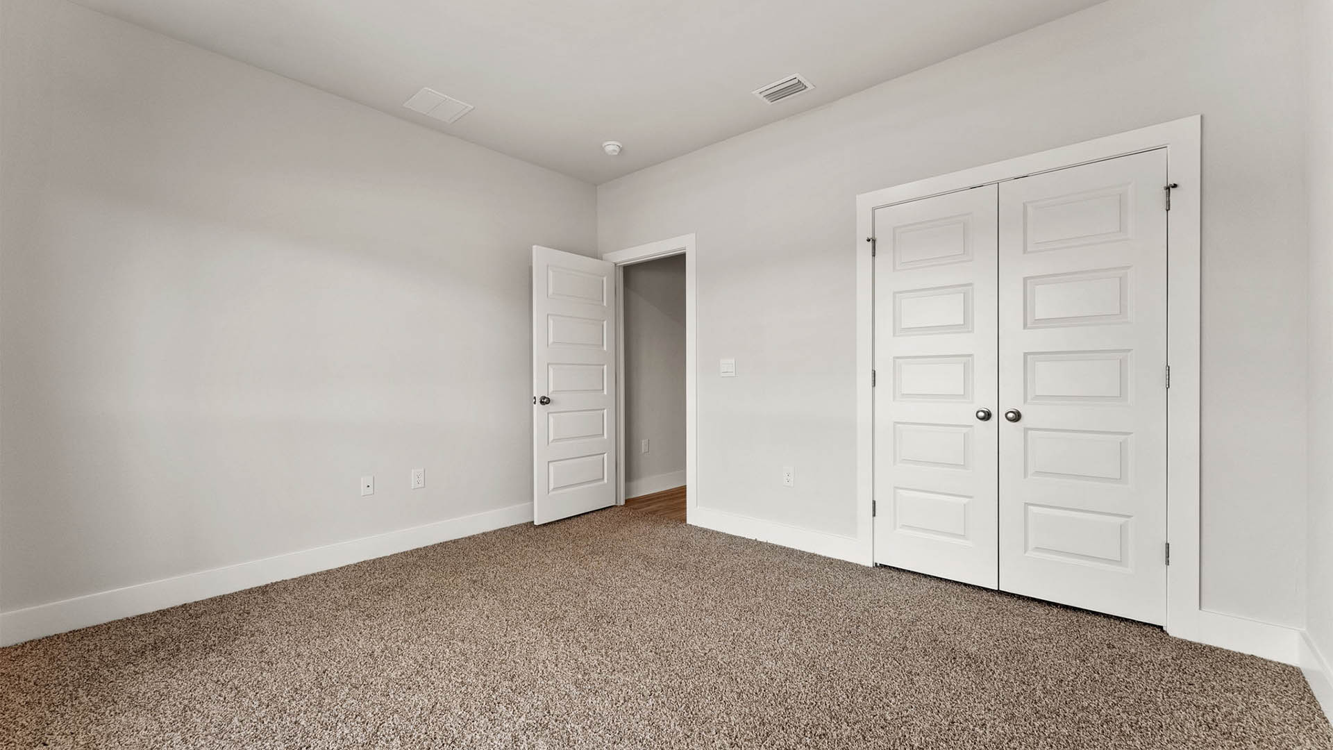 Bedroom with carpet floors and closet.