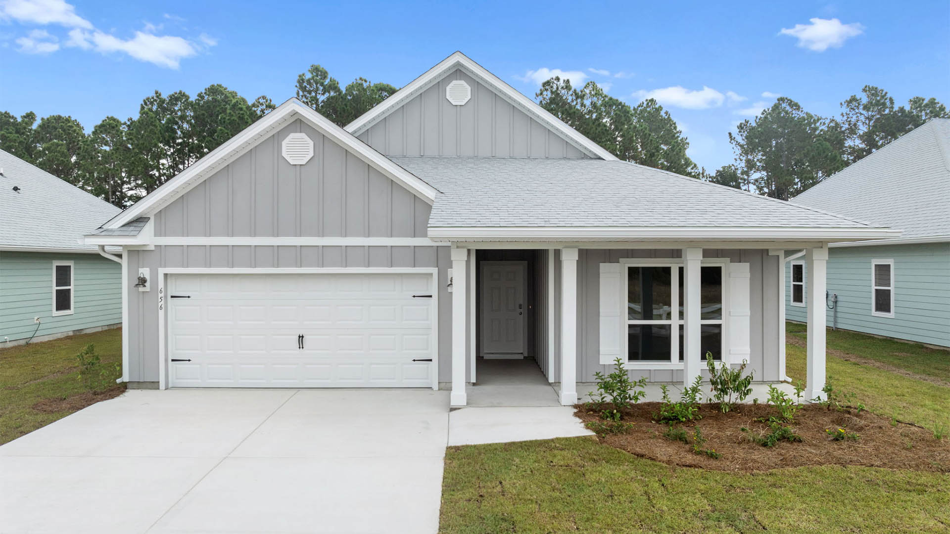 Delray floor plan at Buffer Farms front of home with Hardie siding and covered front porch and two car garage.