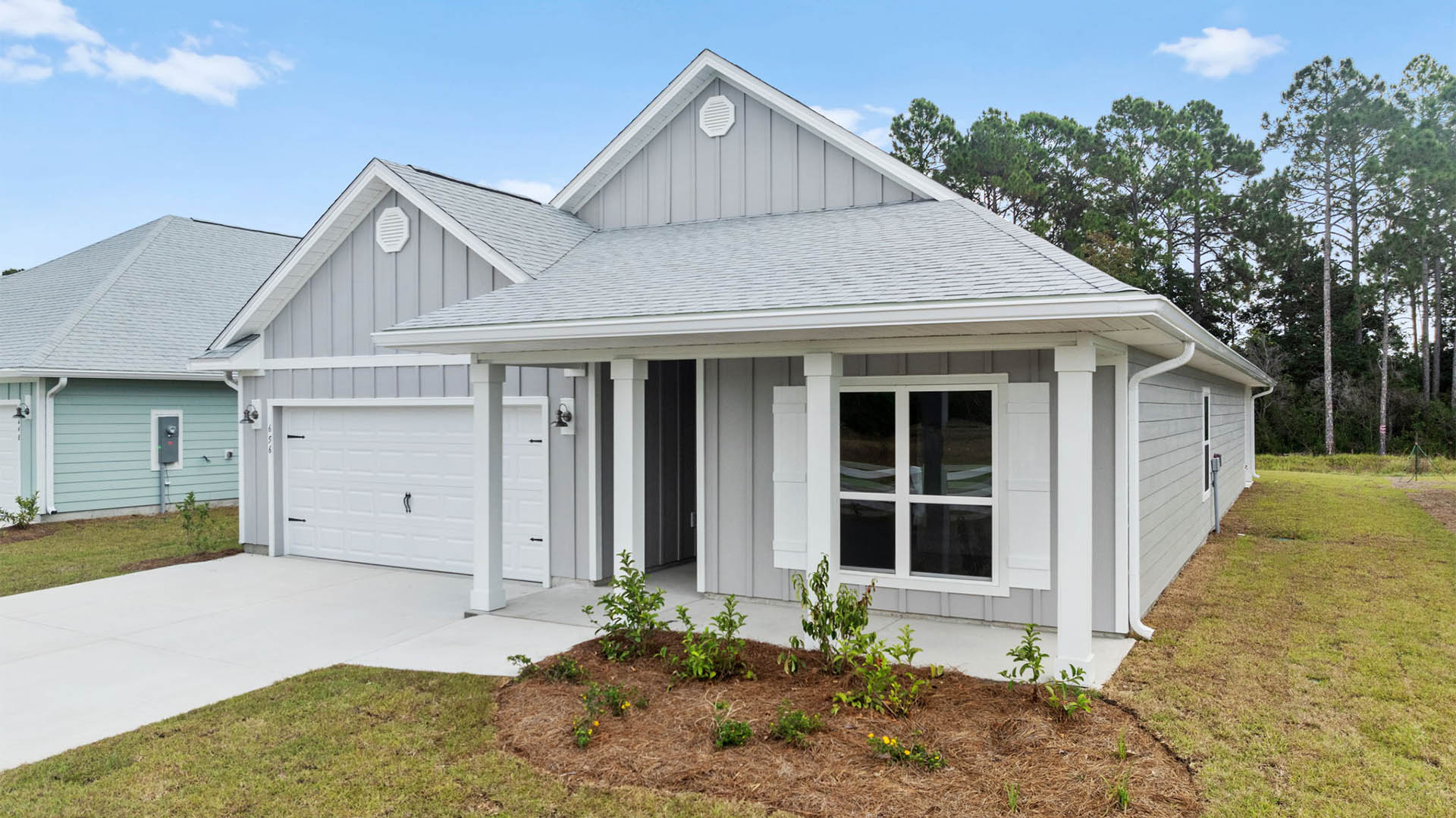 Delray floor plan at Buffer Farms front of home with Hardie siding and covered front porch and two car garage.
