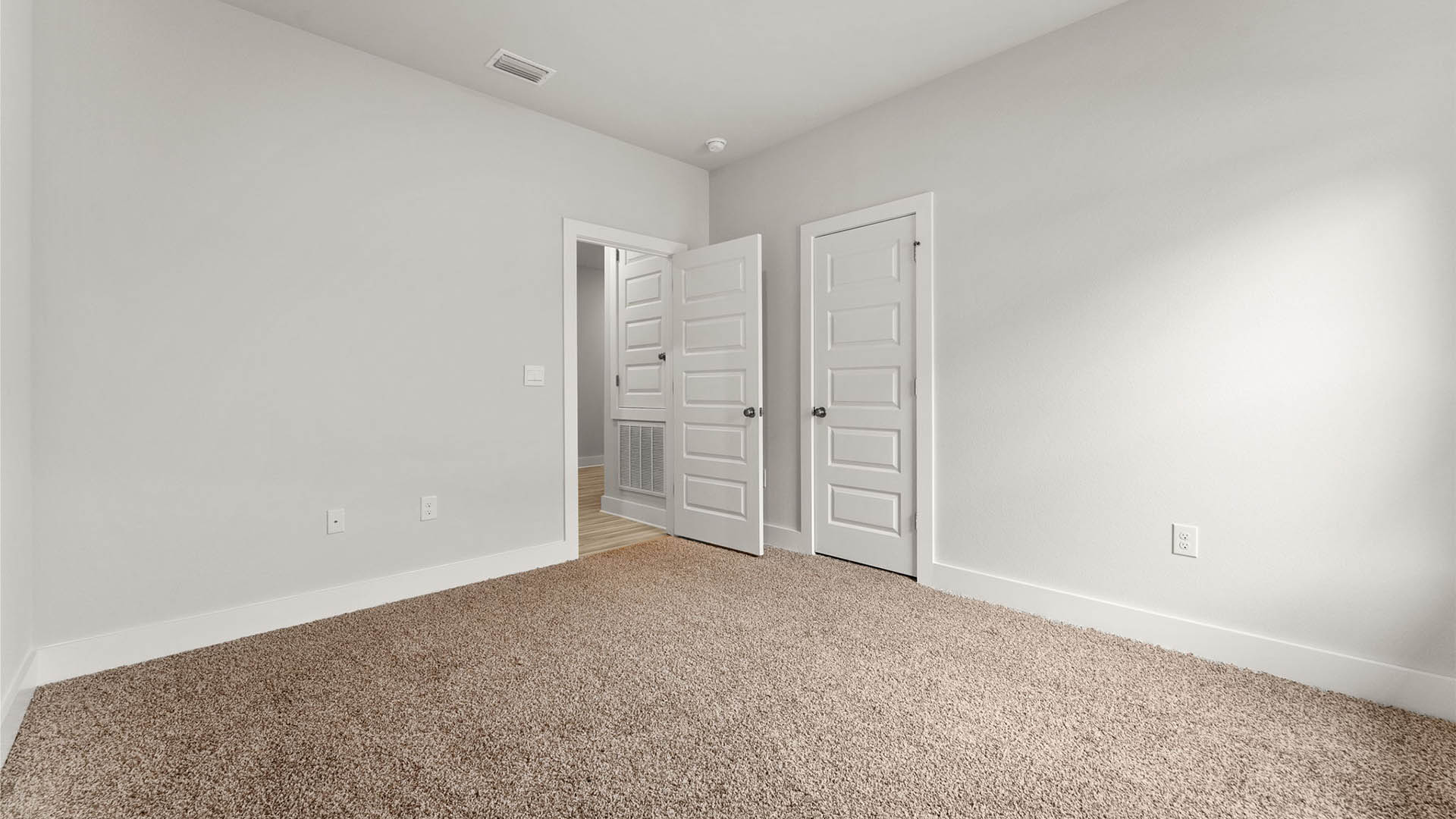 Bedroom with carpet floors and closet.