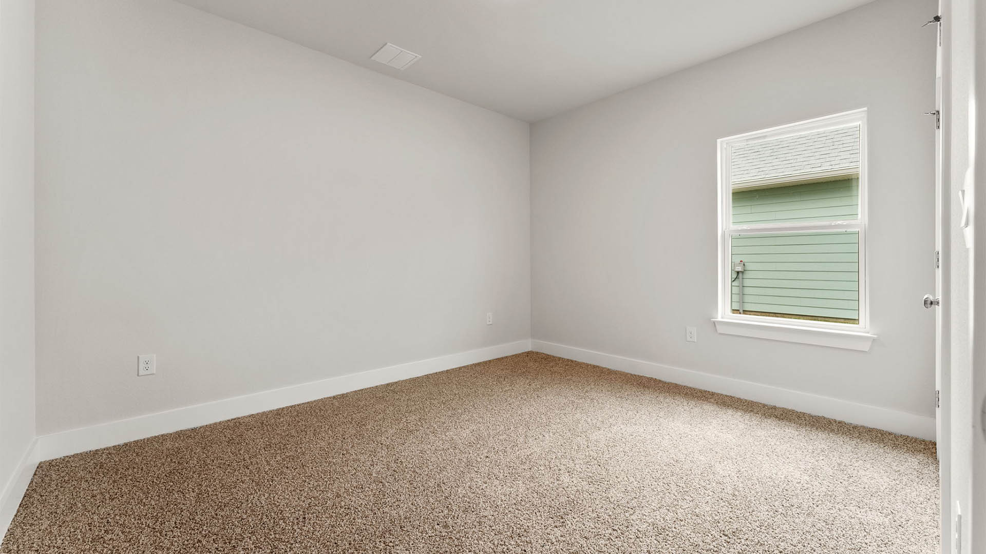 Bedroom with carpet floors and window.