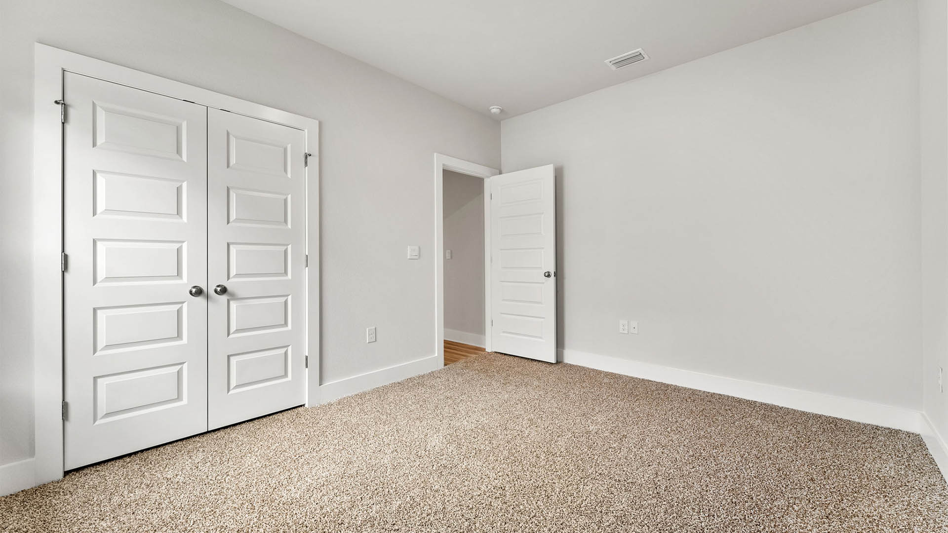 Bedroom with carpet floors and closet.
