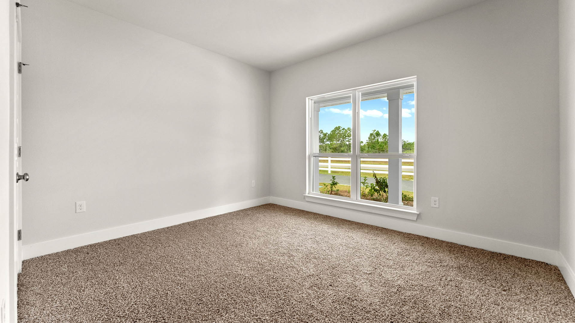 Bedroom with carpet floors and window.
