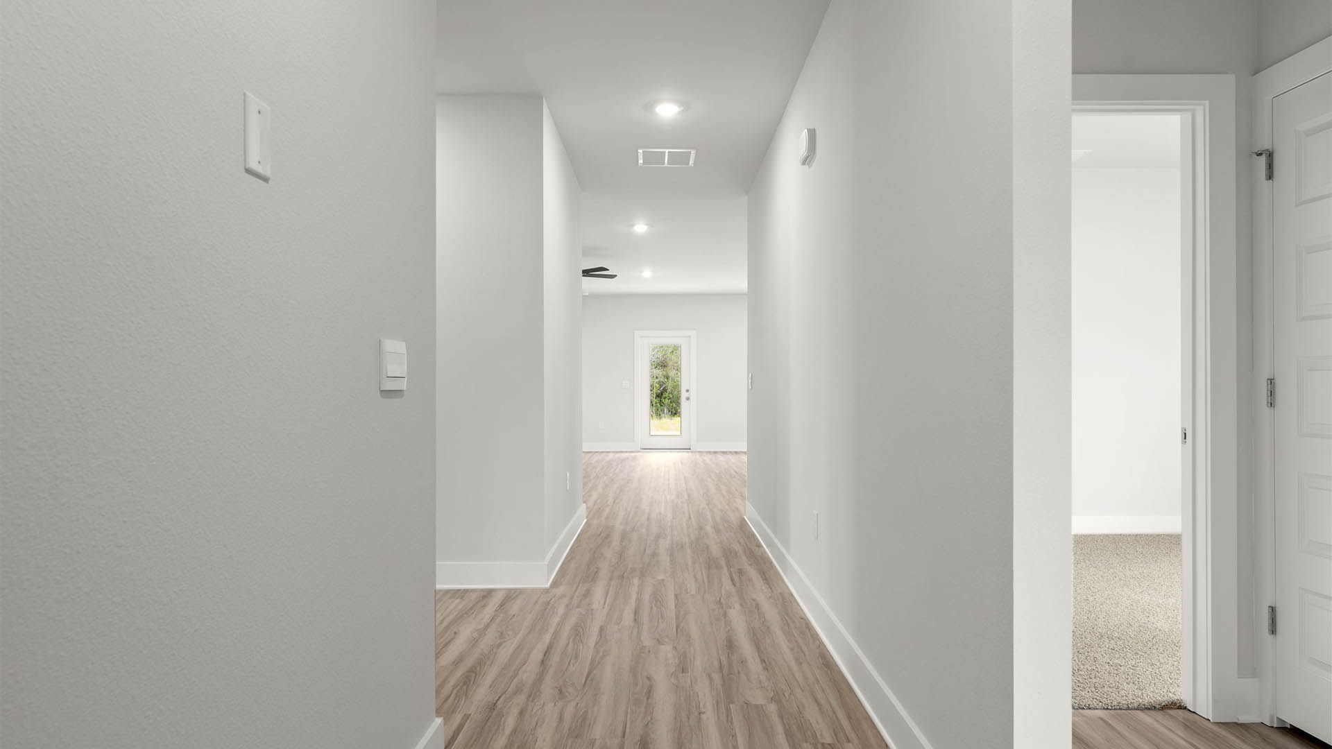 Front entrance with EVP flooring next to bedrooms and bathroom.