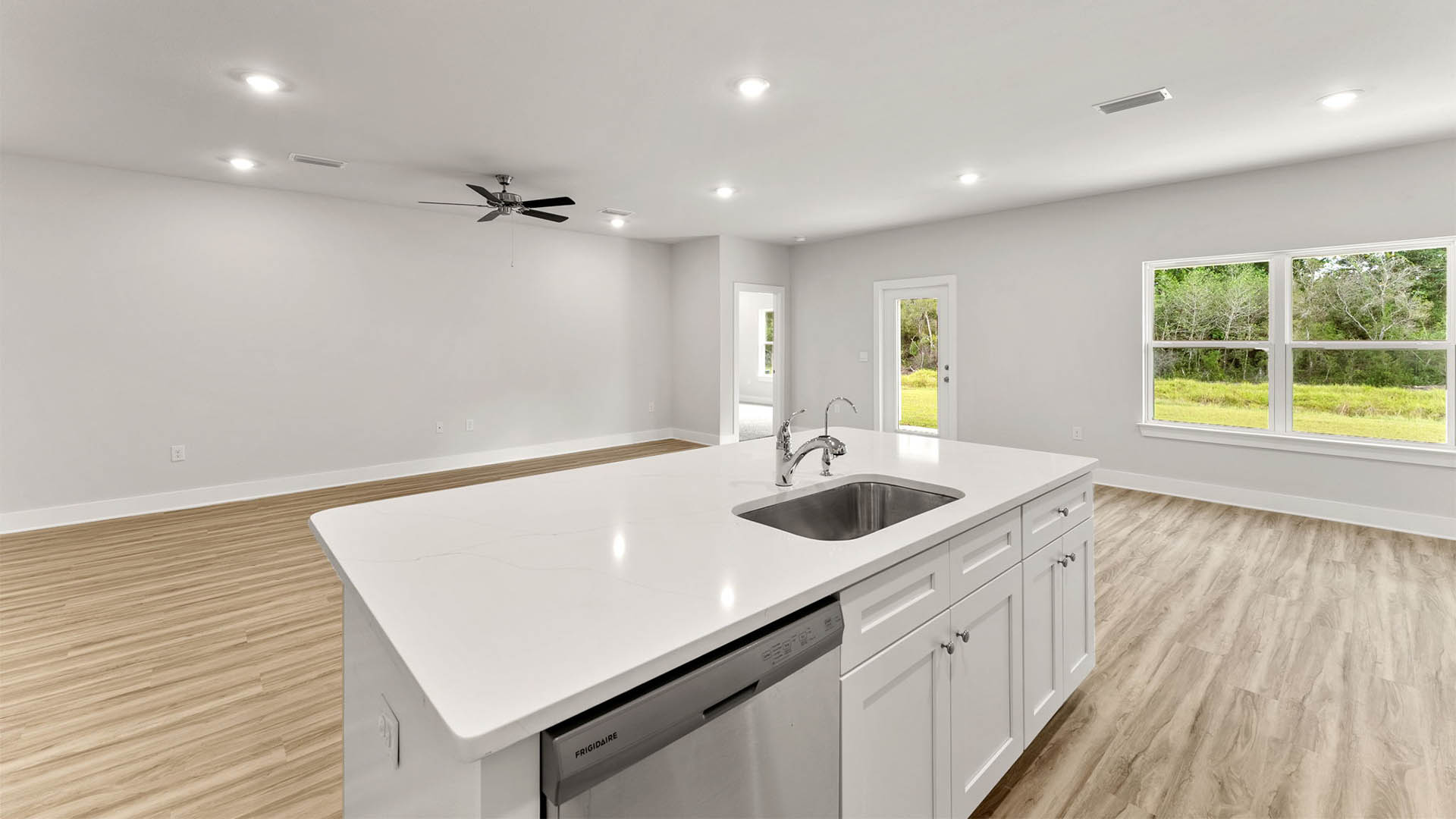 Kitchen island with quartz countertops and farm style sink.
