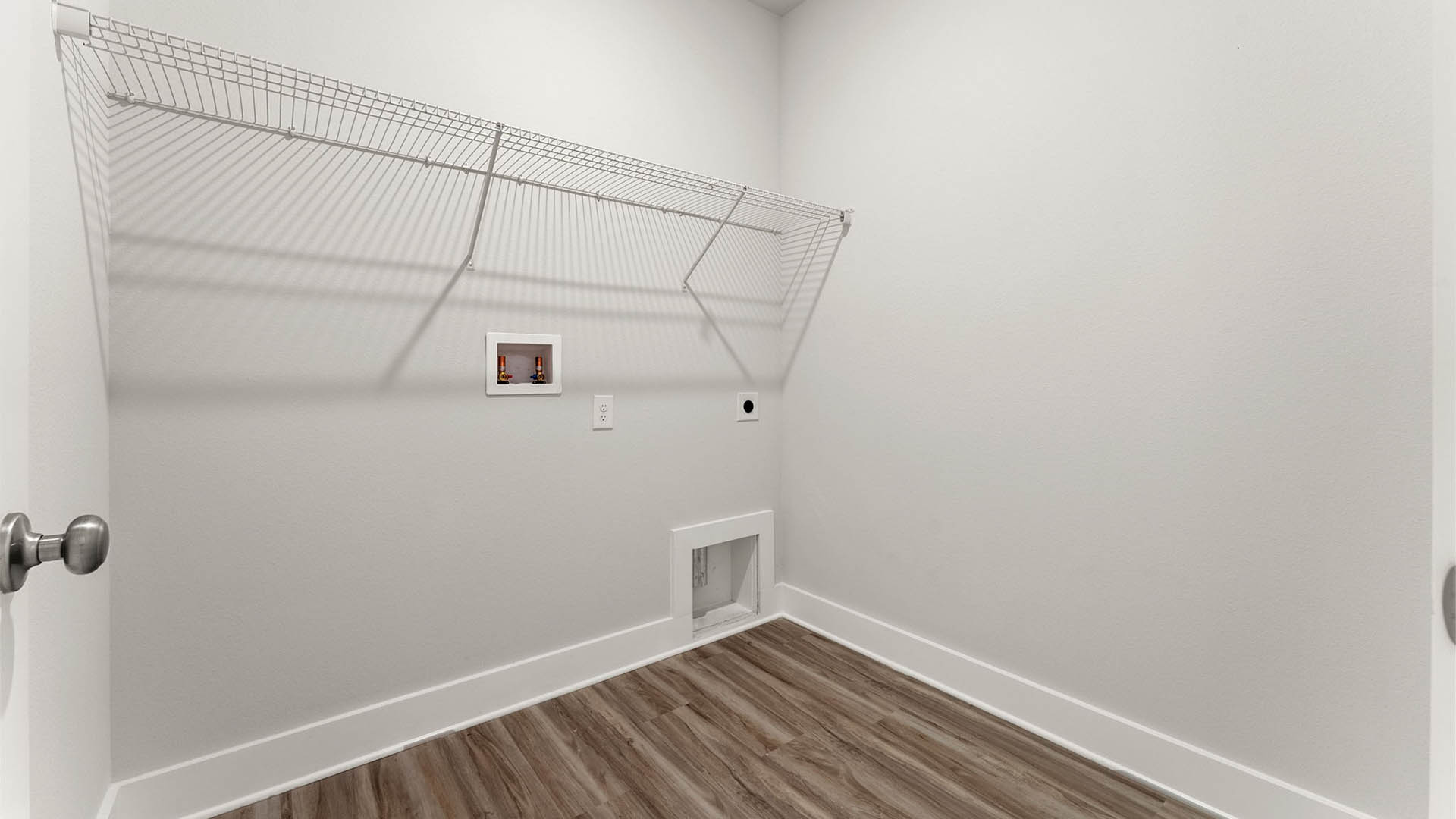 Laundry room with EVP flooring and ventilated shelving.