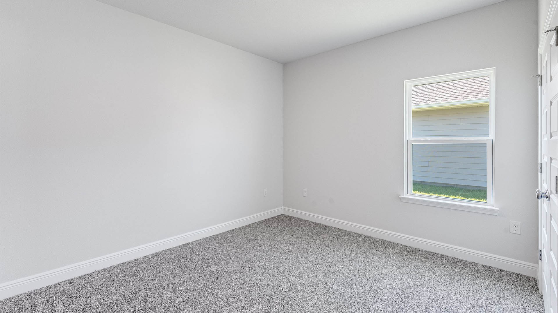 Bedroom with carpet floors and window.