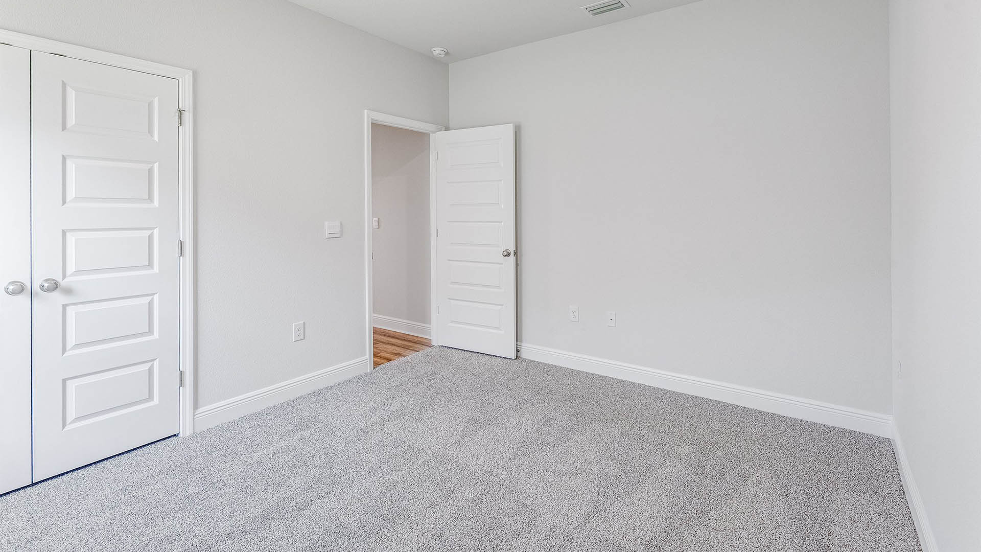 Bedroom with carpet floors and closet.