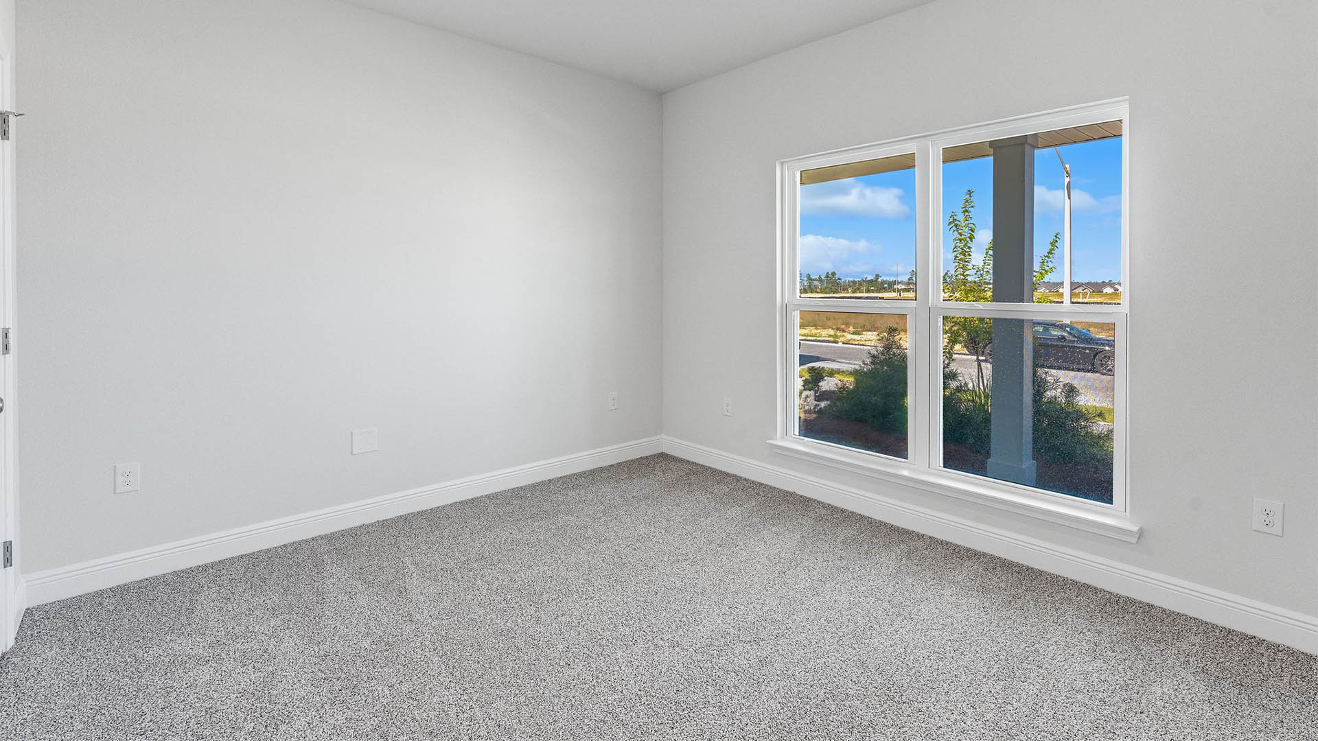 Bedroom with carpet floors and window.