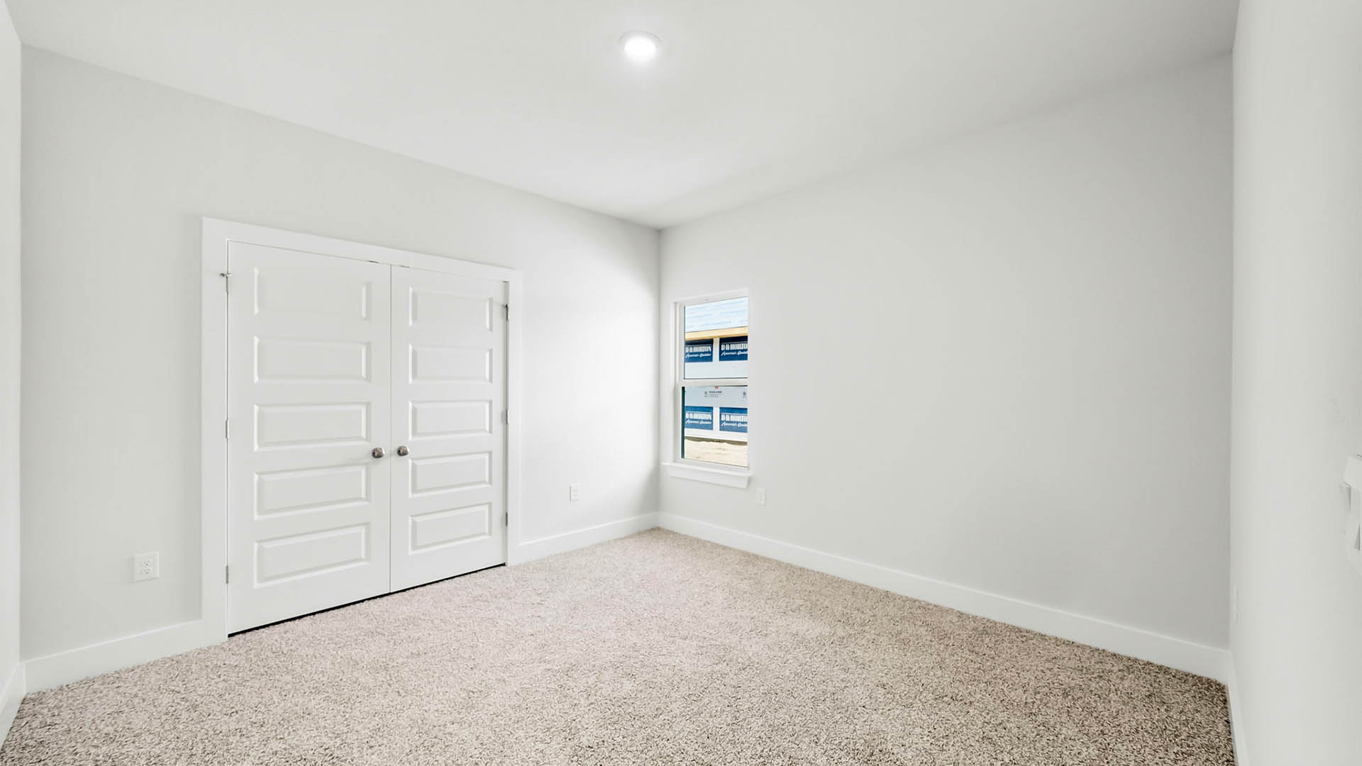 Bedroom with carpet flooring and window.