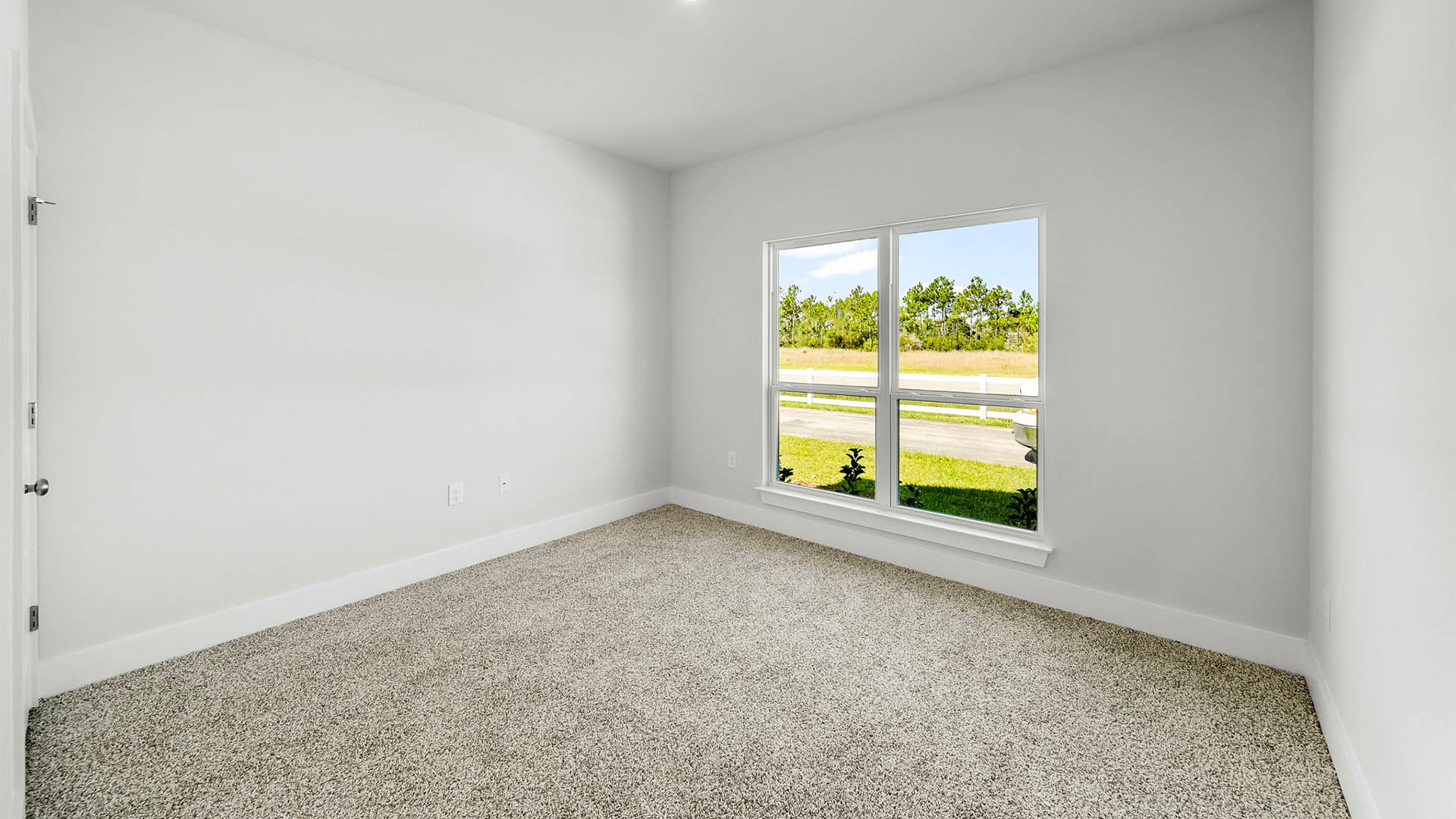 Bedroom with carpet flooring and window.
