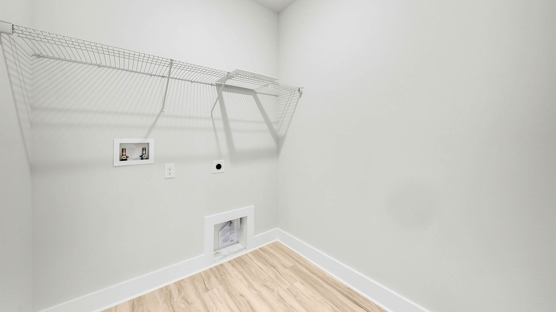 Laundry room with EVP flooring and ventilated shelving.