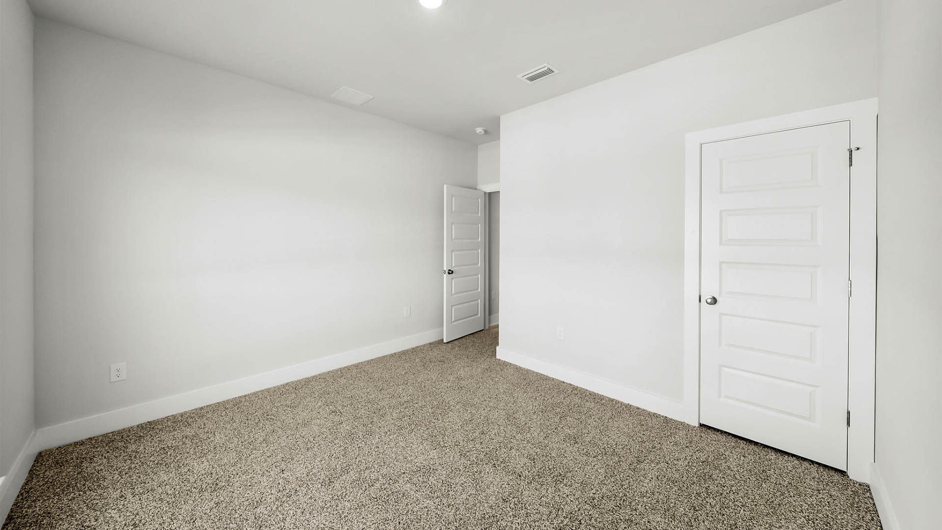 Bedroom with carpet flooring and closet.