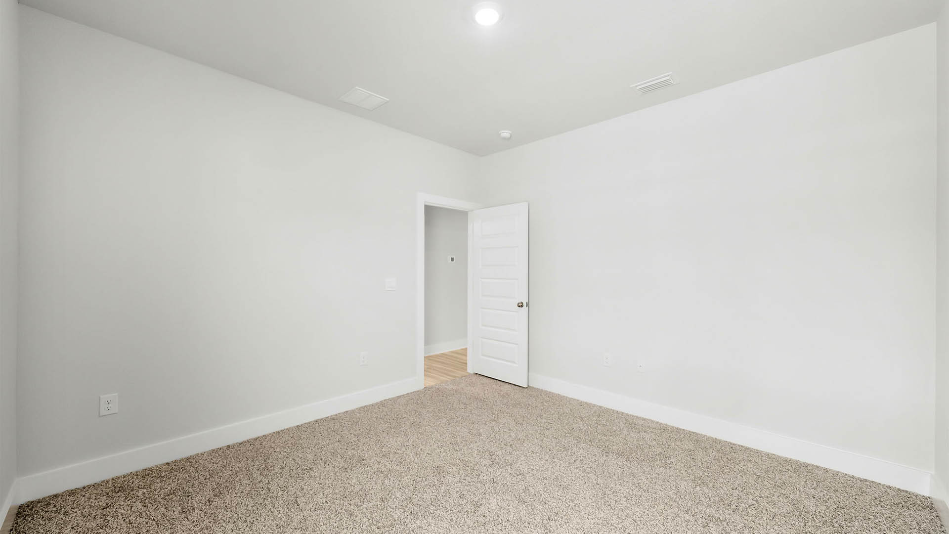 Bedroom with carpet flooring and closet.