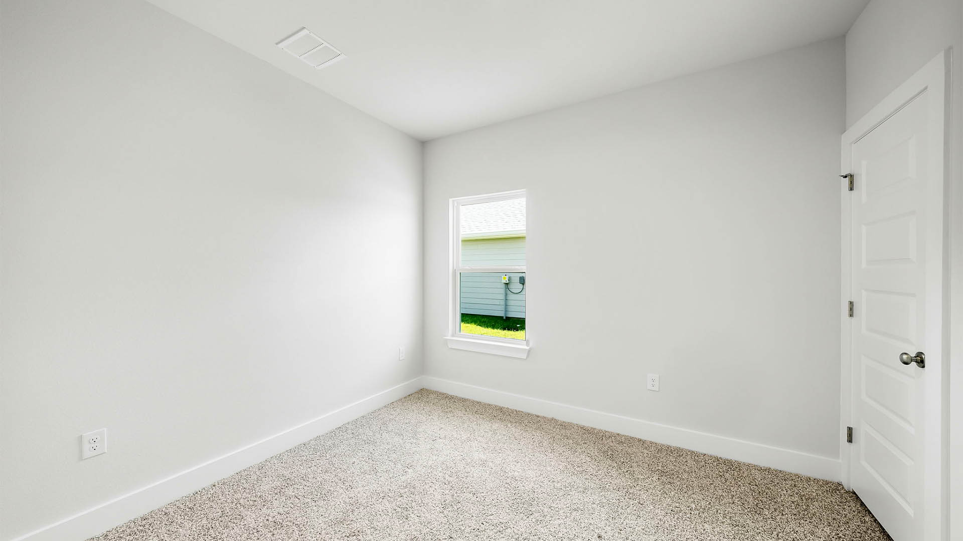 Bedroom with carpet flooring and window.