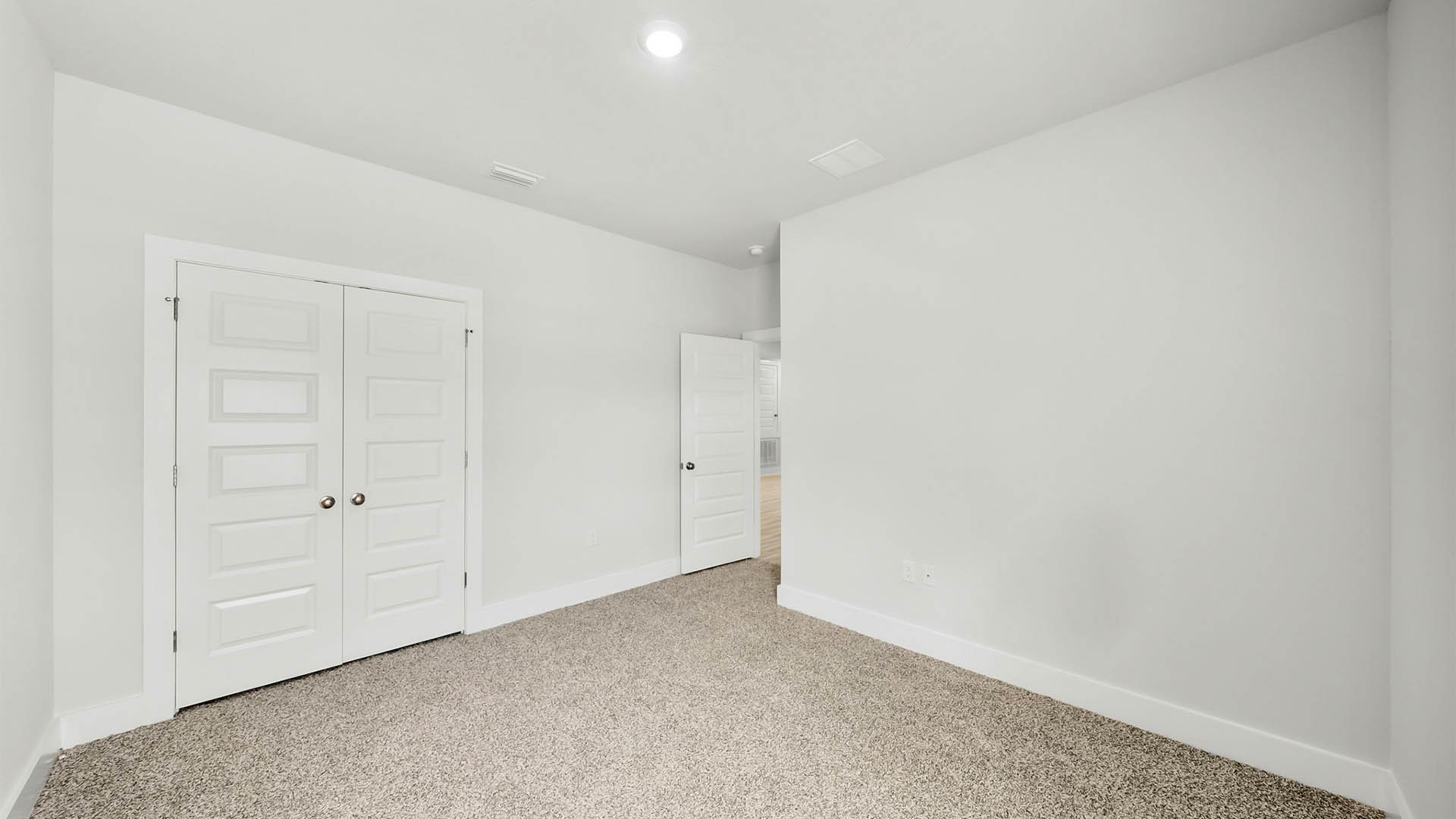 Bedroom with carpet flooring and closet.