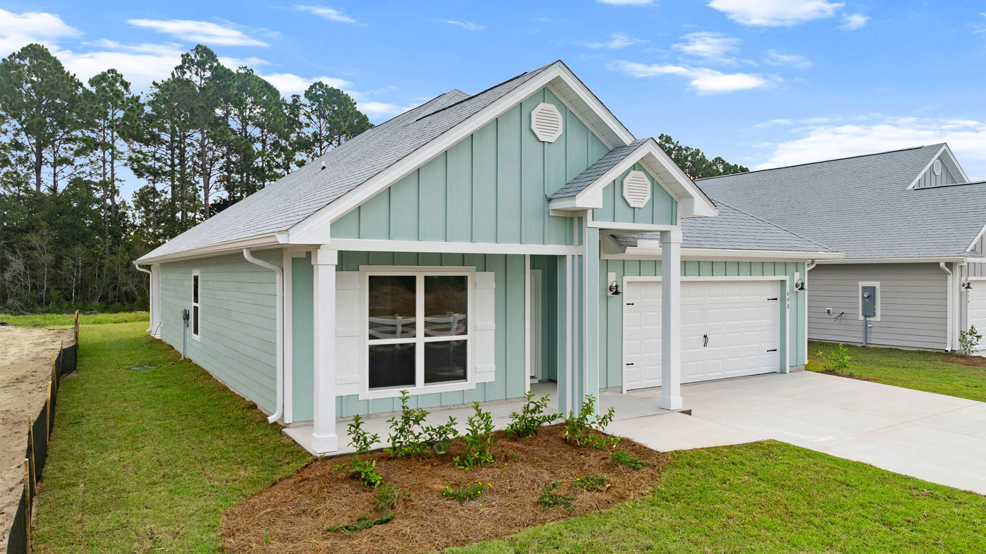 Rhett floor plan at Buffer Farms with Hardie Board siding and two-car garage and covered front porch.
