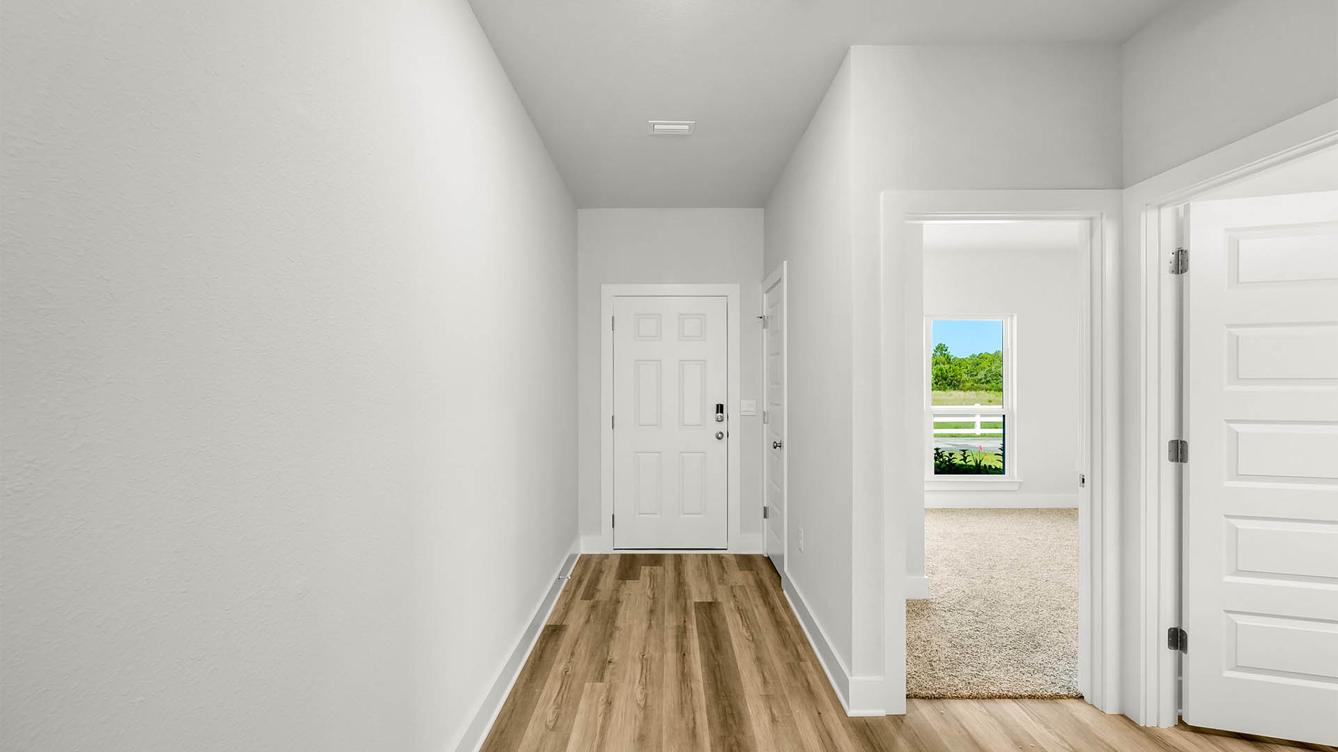 Front entrance with front door and closet next to bedrooms and bathroom.