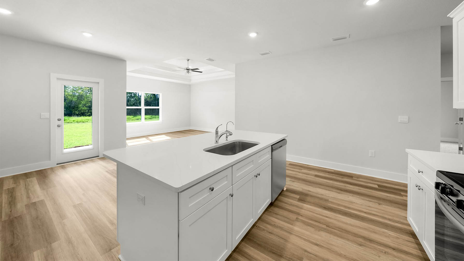 Kitchen island with dishwasher and quartz countertops.