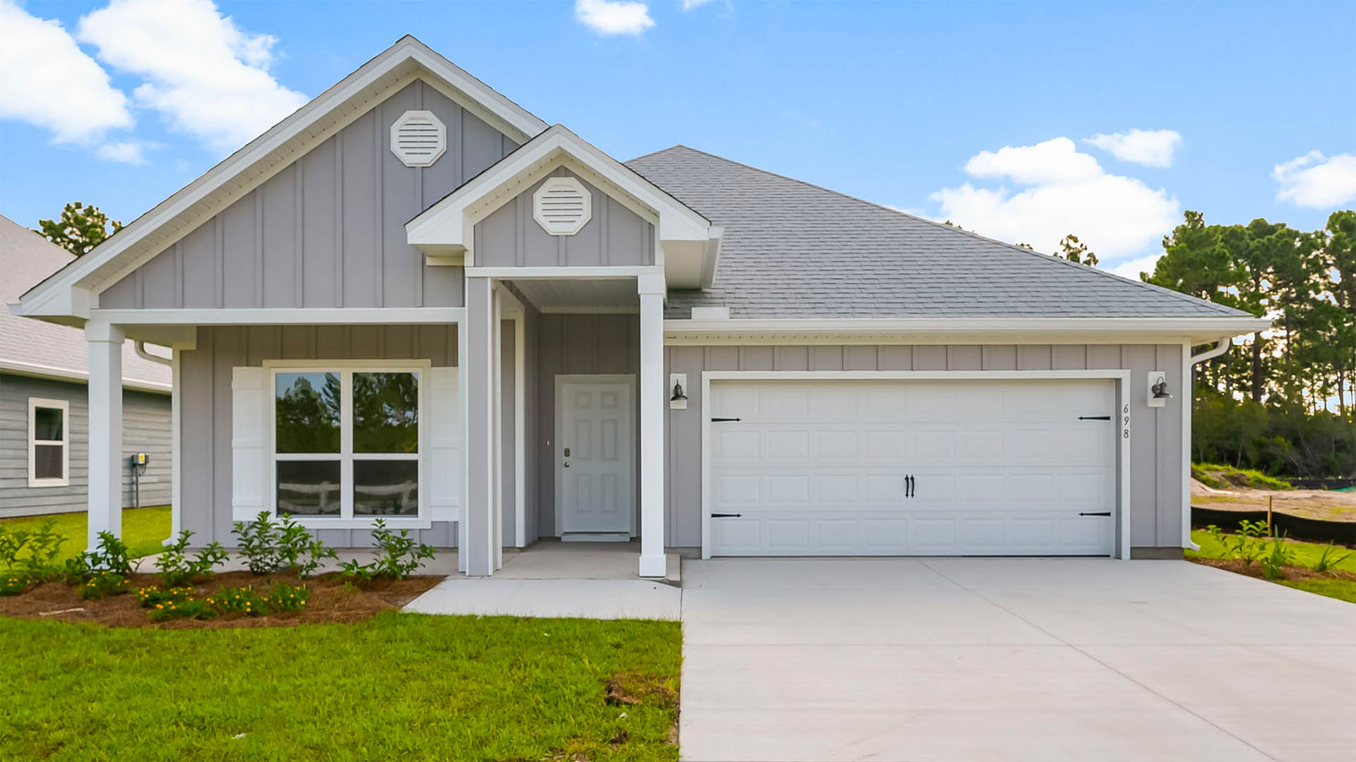 Rhett floor plan at Buffer Farms with Hardie Board siding and two-car garage and covered front porch.