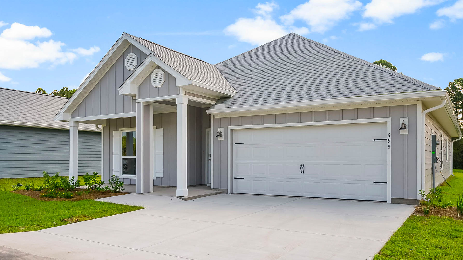 Rhett floor plan at Buffer Farms with Hardie Board siding and two-car garage and covered front porch.
