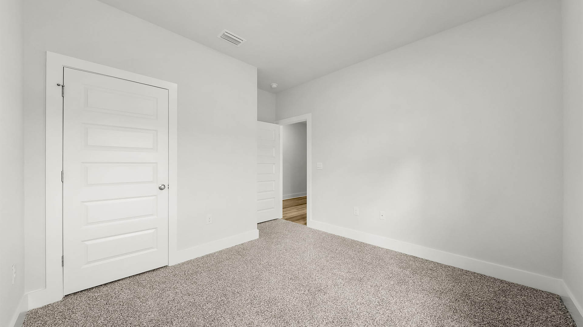 Bedroom with carpet floor and closet.