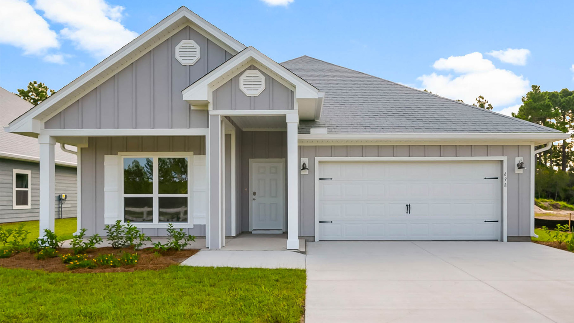 Rhett floor plan at Buffer Farms with Hardie Board siding and two-car garage and covered front porch.