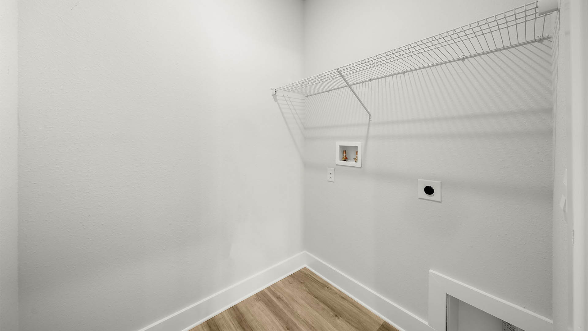Laundry room with EVP flooring and ventilated shelving.