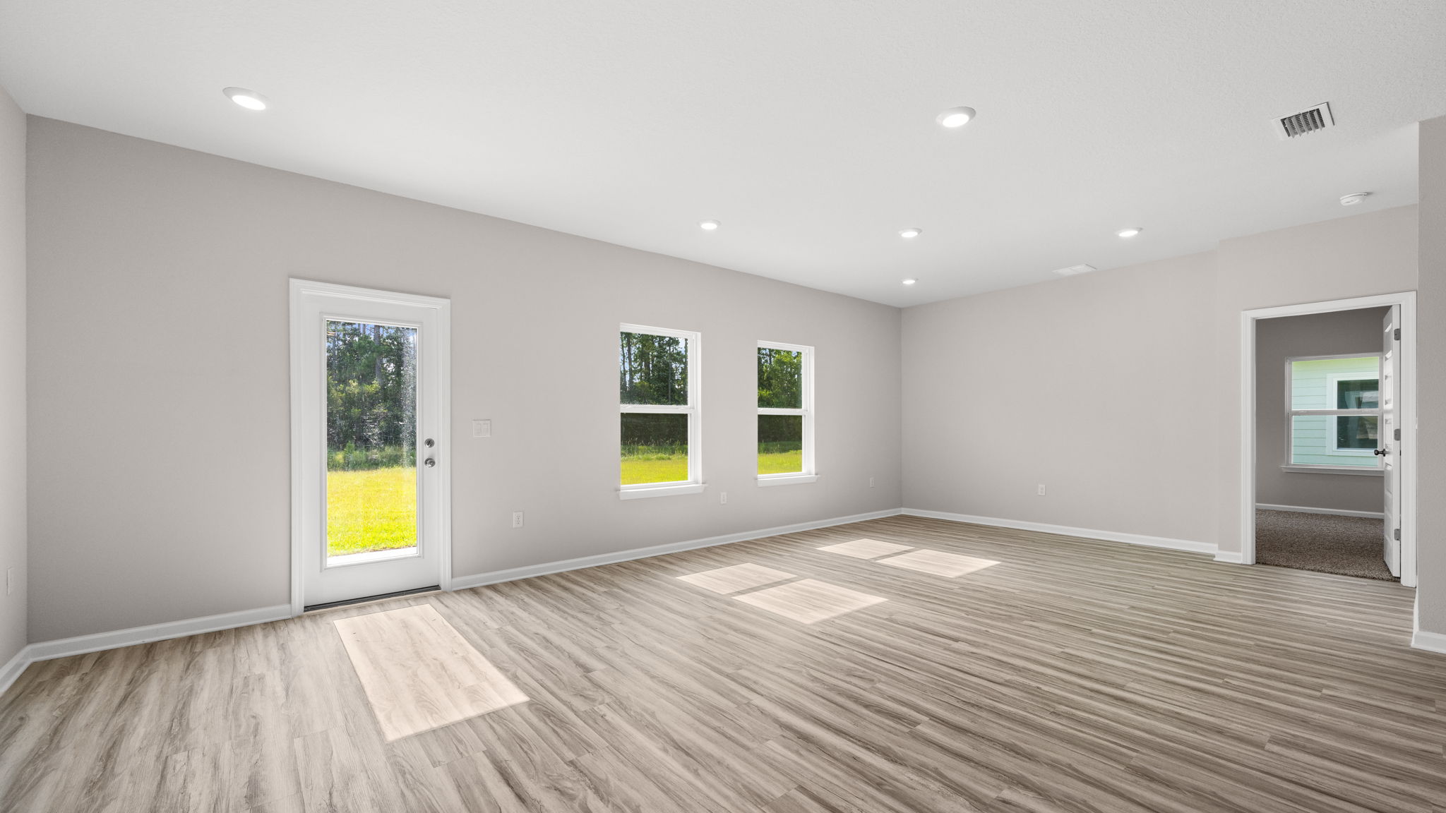 Living room and dining area next to back door.