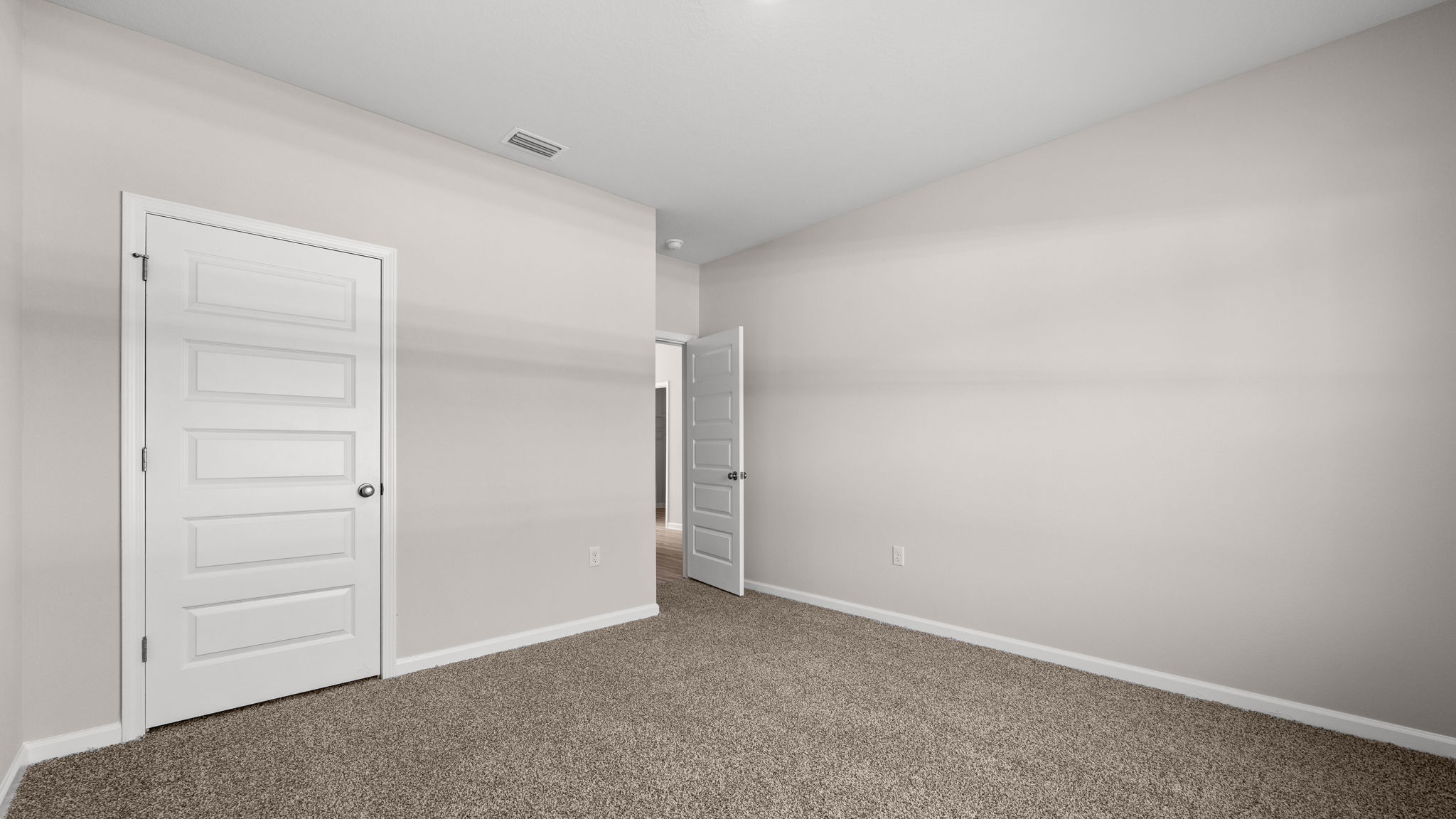 Bedroom with carpet floor and closet.