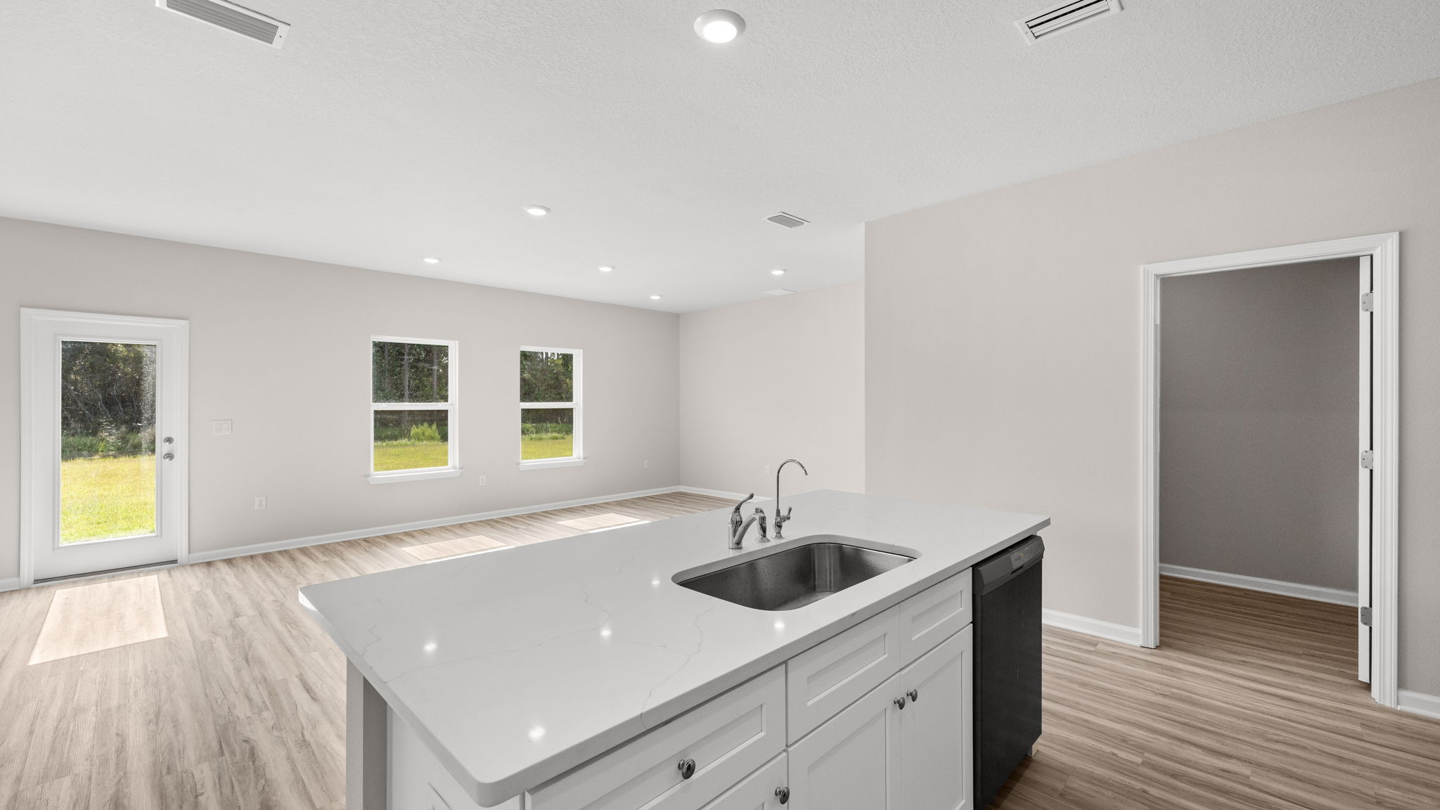 Living room and kitchen view next to pantry.