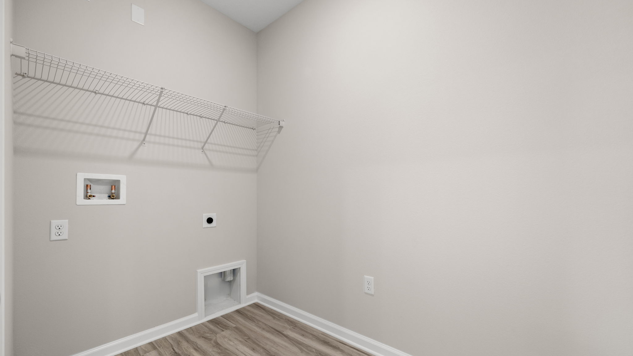 Laundry room in hallway with ventilated shelving.