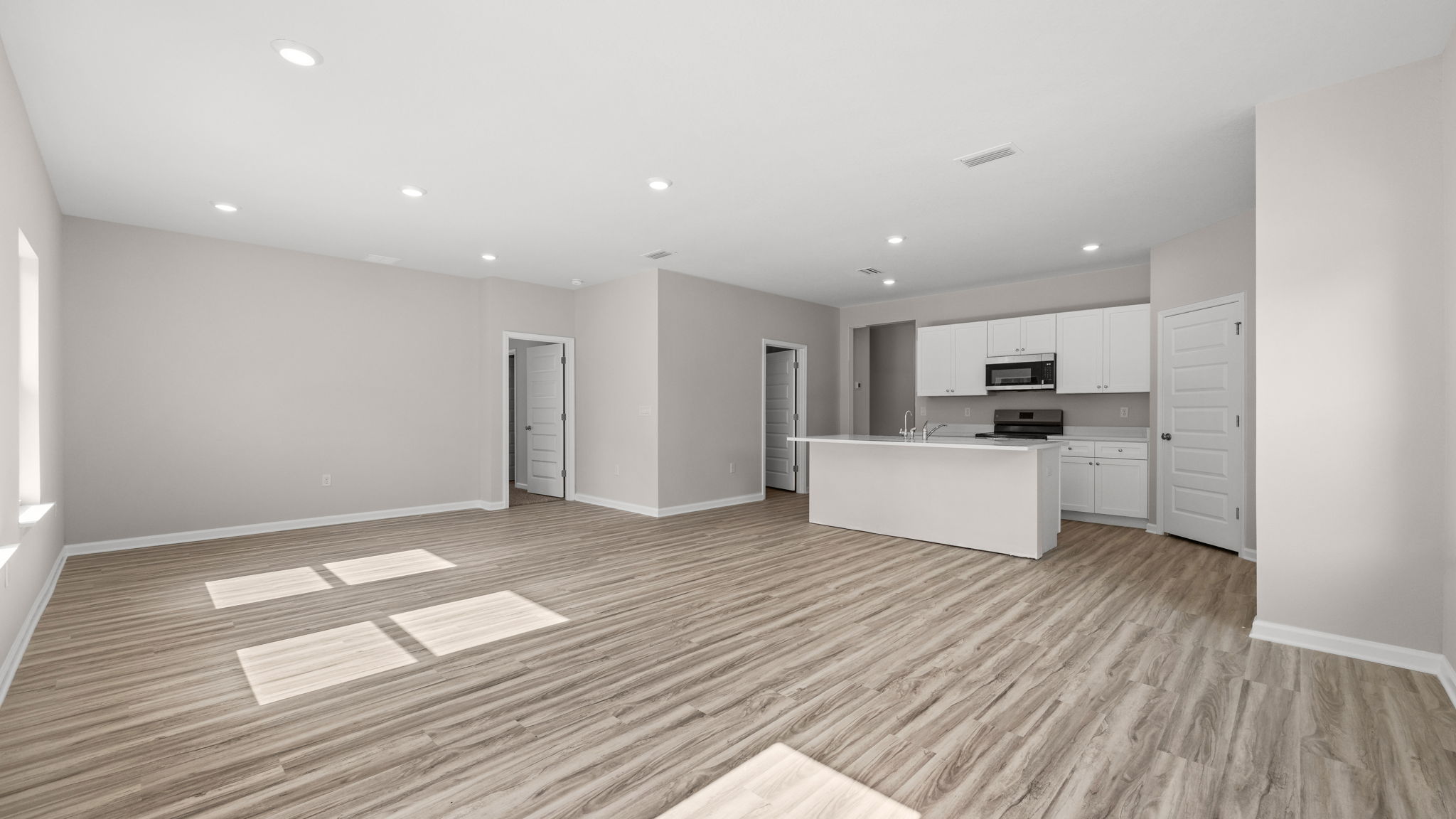 Living room and dining area next to back door.