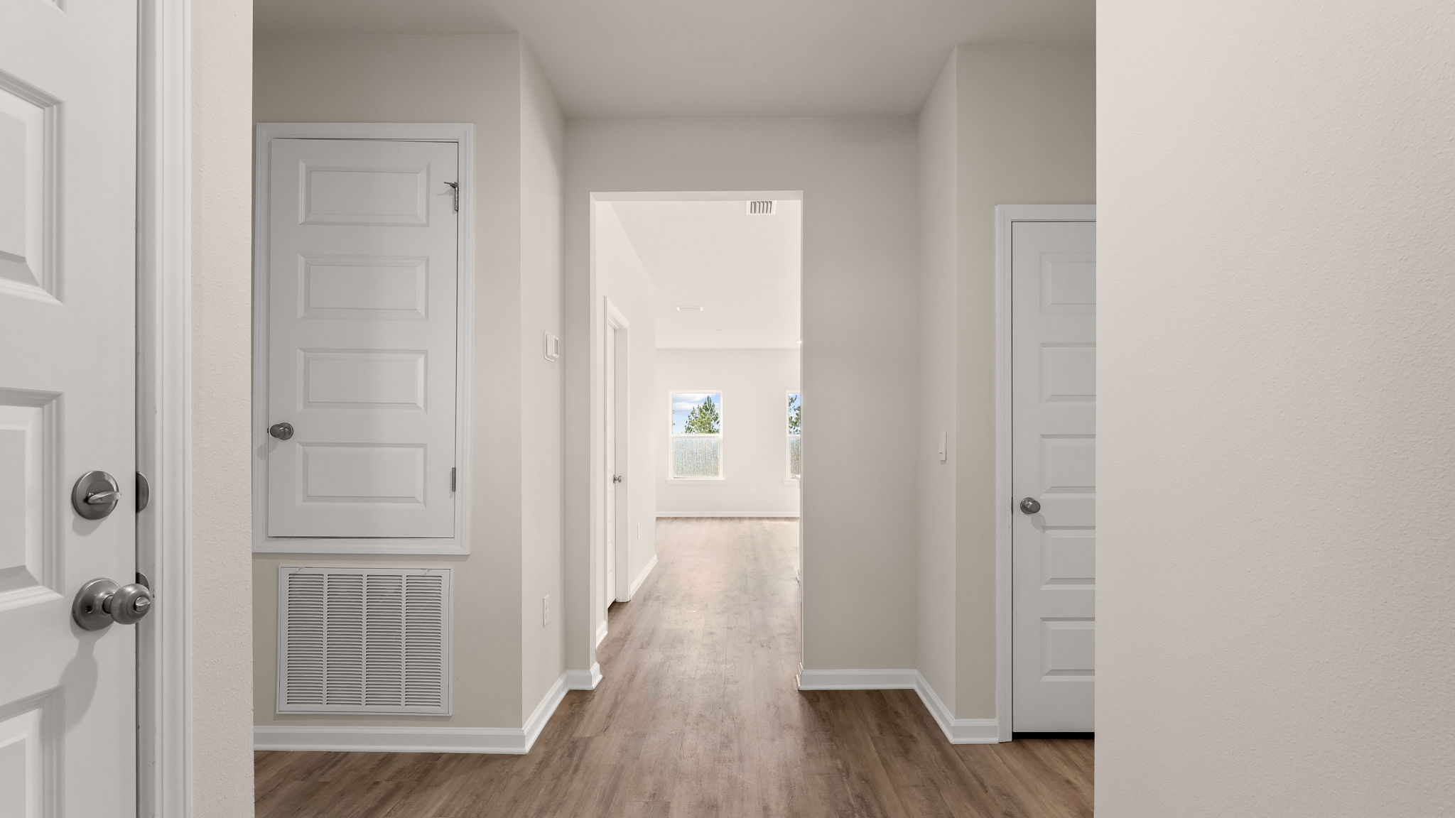 Front entrance hallway with EVP flooring next to garage and bedrooms.
