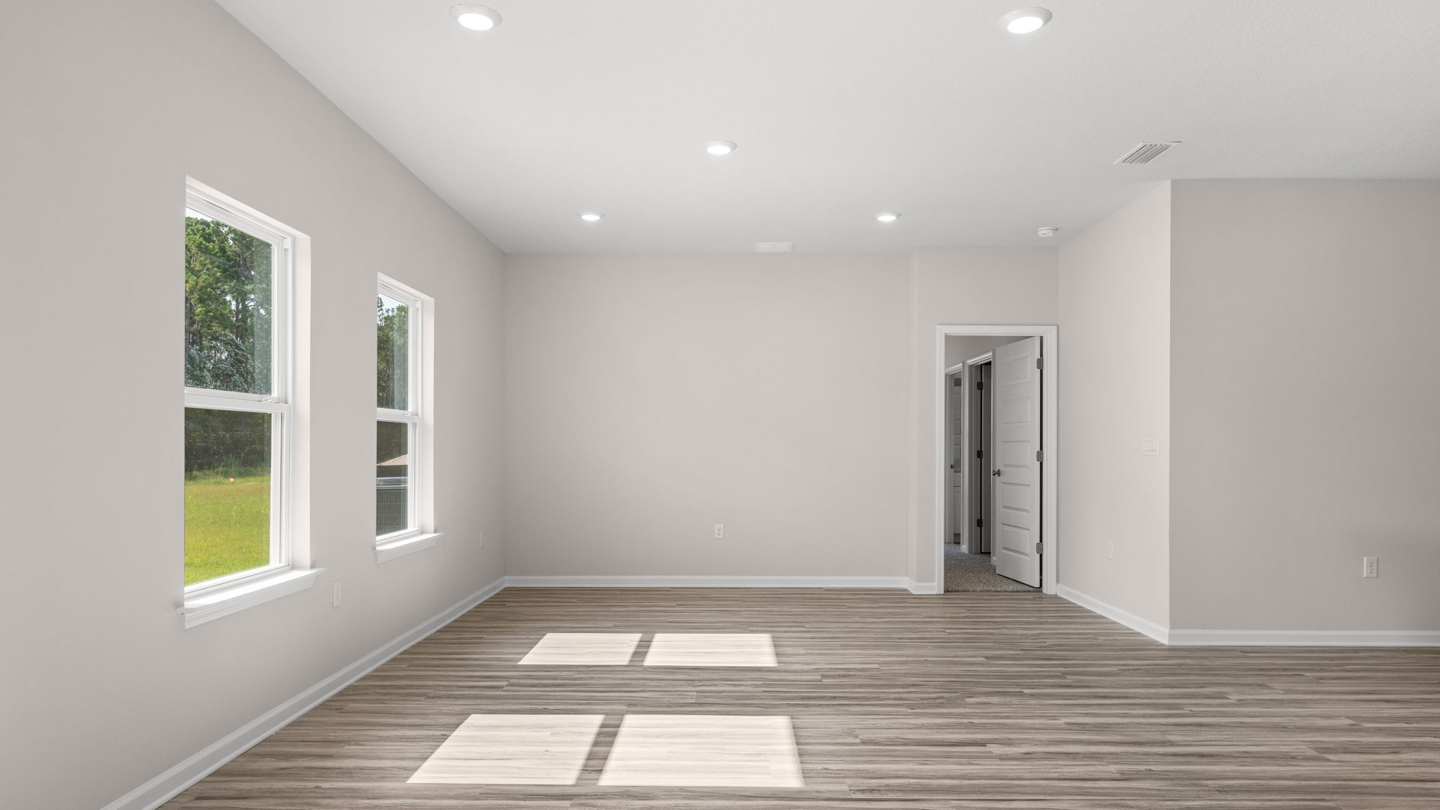 Living room and dining area next to back door.