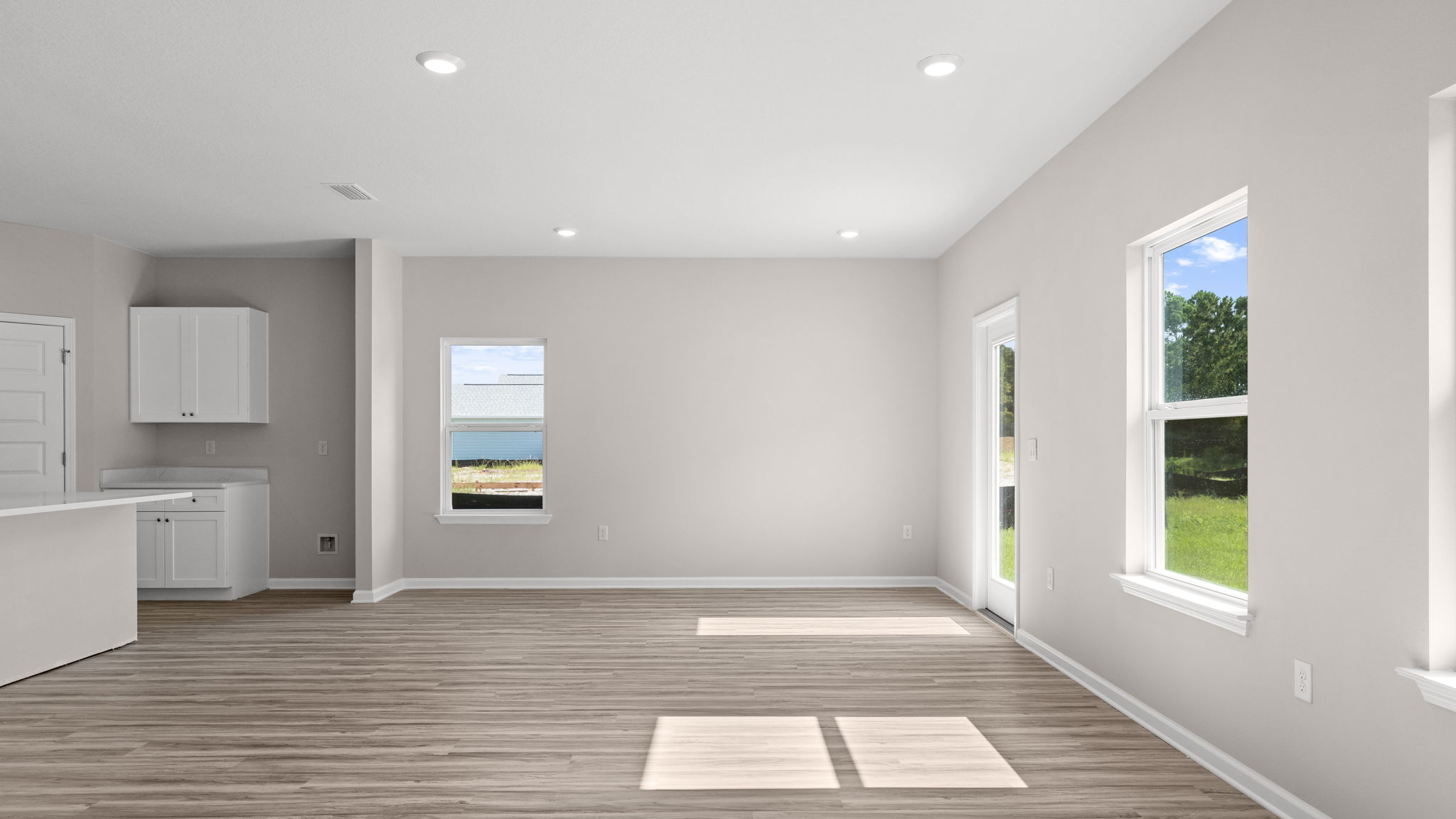Living room and dining area next to back door.