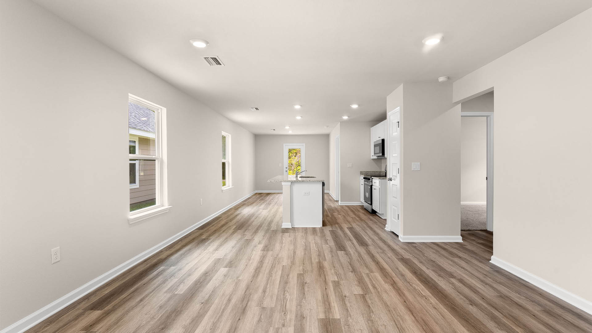 Open living room and kitchen with EVP flooring.