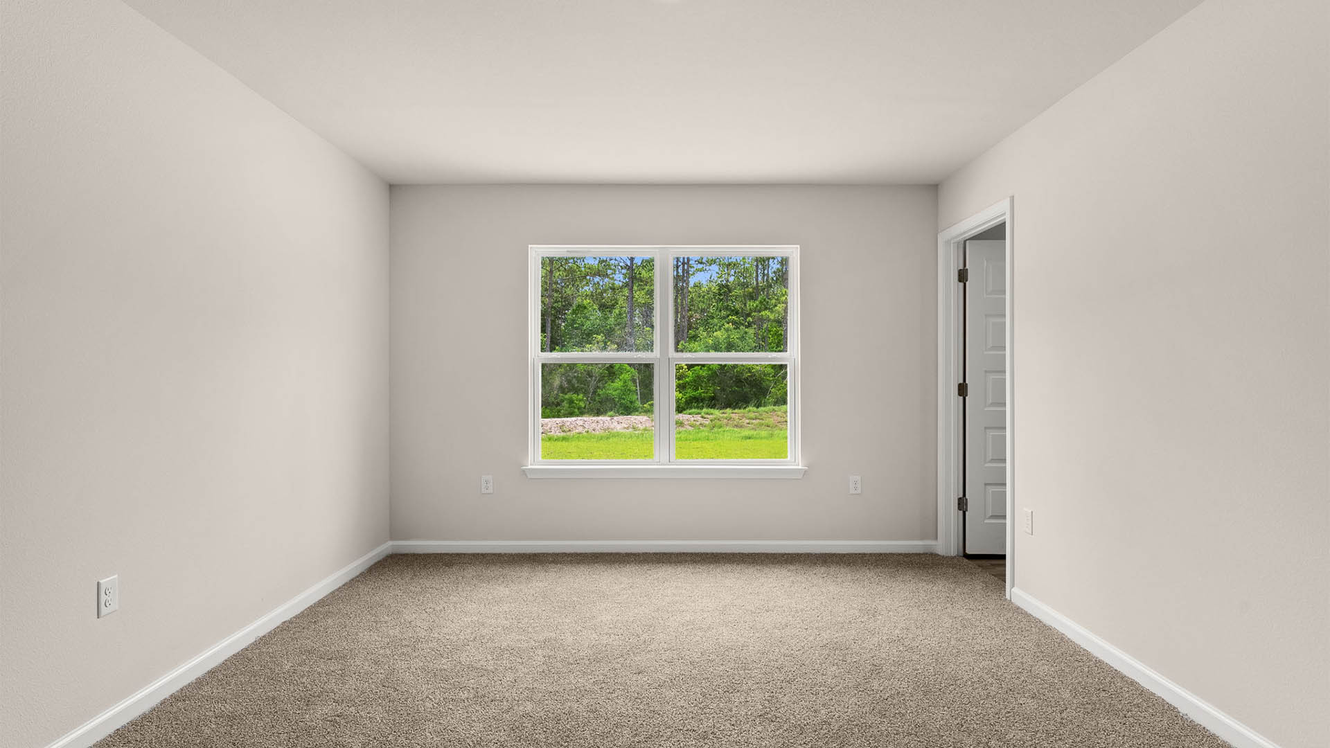 Primary bedroom with carpet flooring and two windows with bathroom.