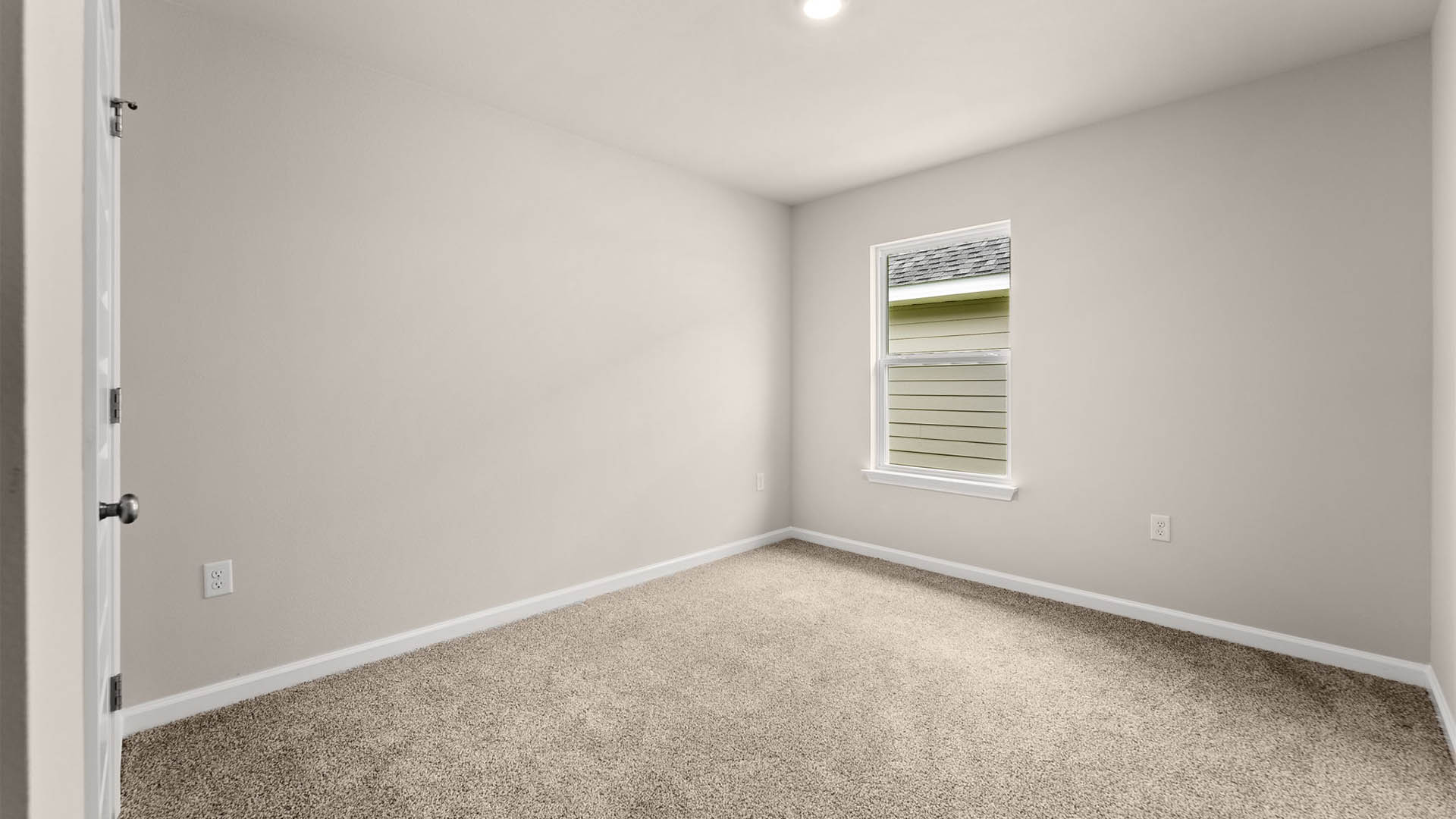 Bedroom with carpet floors and window.
