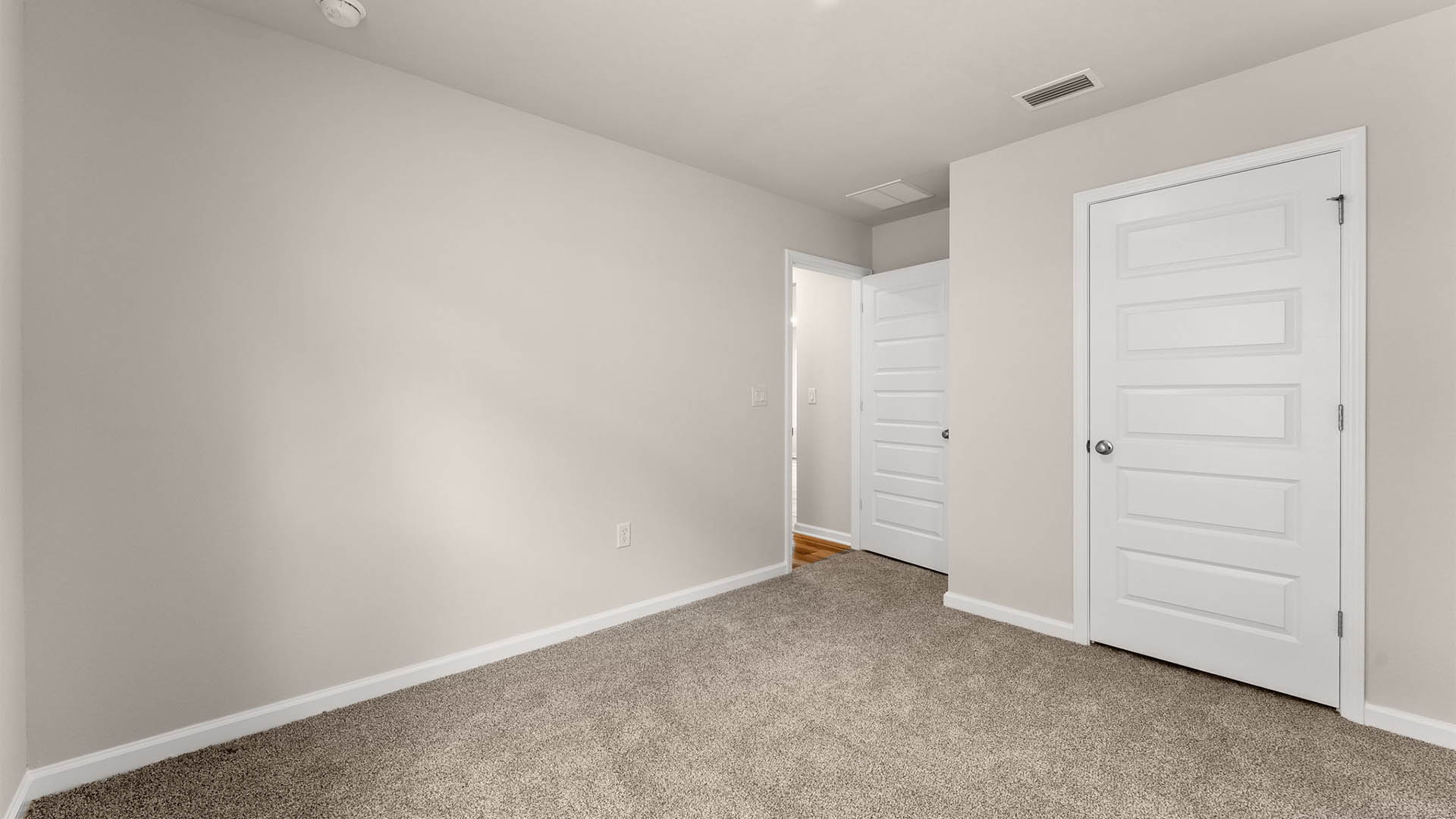 Bedroom with carpet floors and closet.