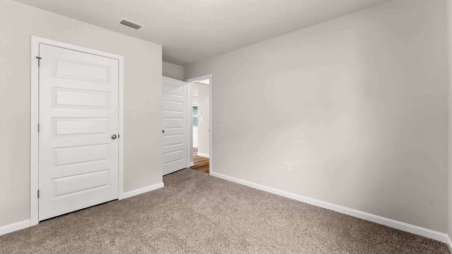 Bedroom with carpet floors and closet.
