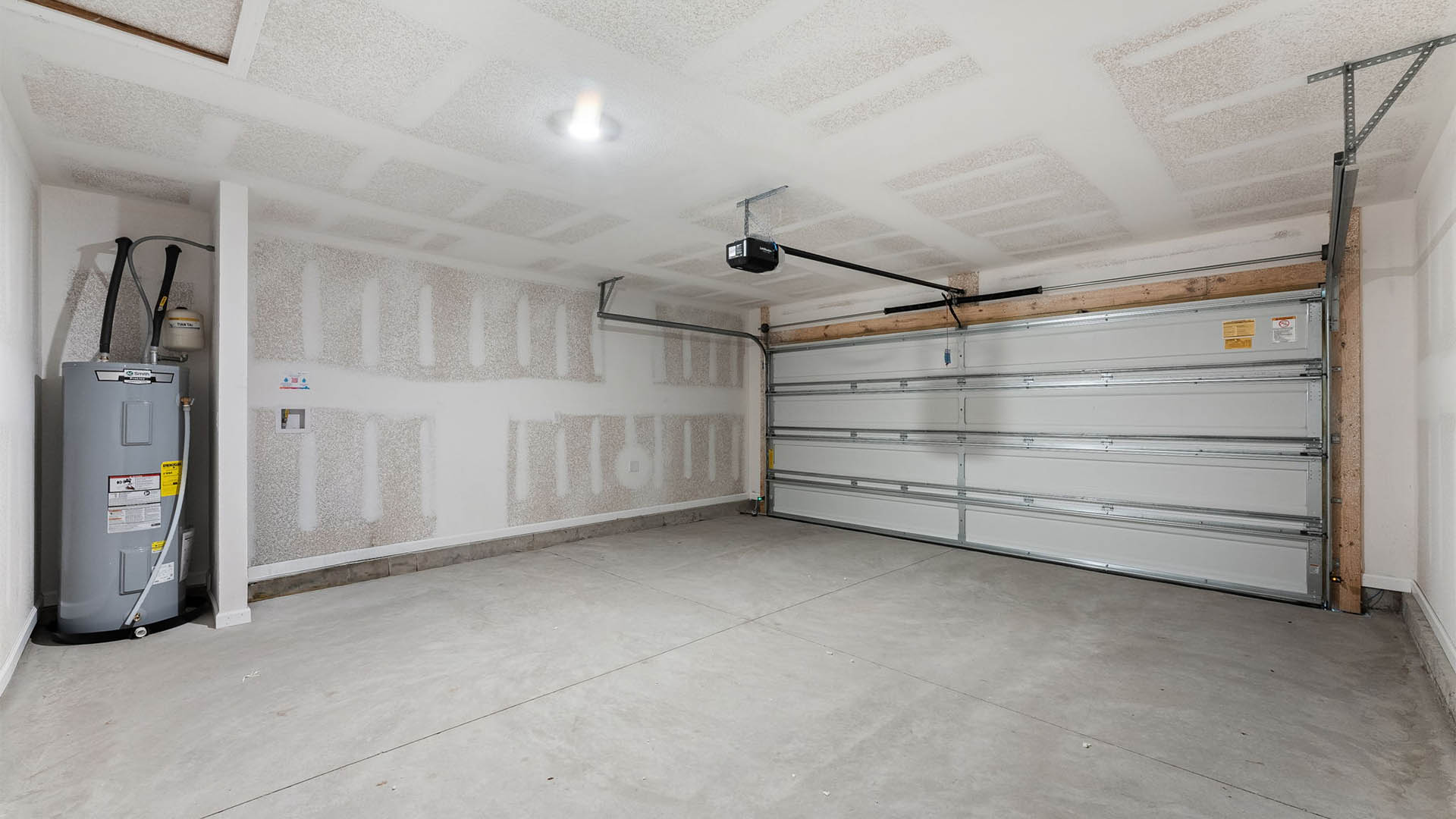 Two car garage with water heater.