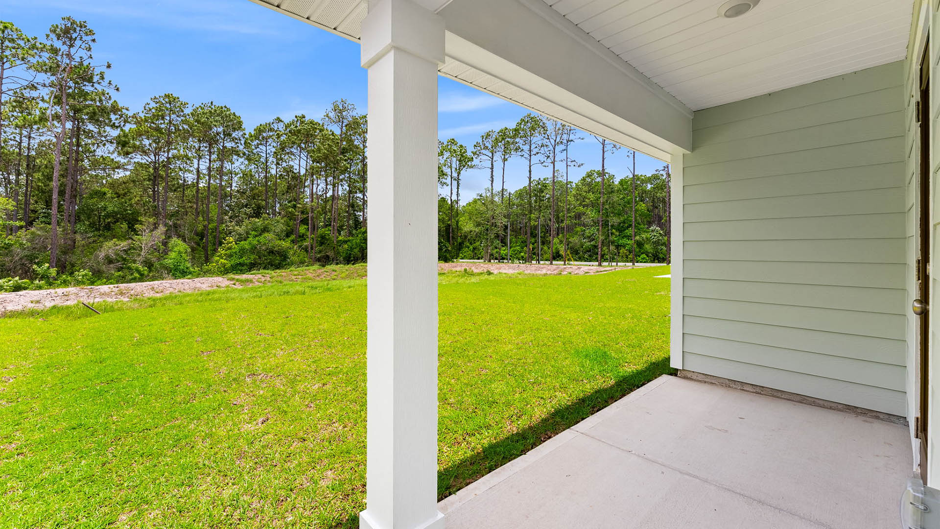 Covered rear patio view of back yard.