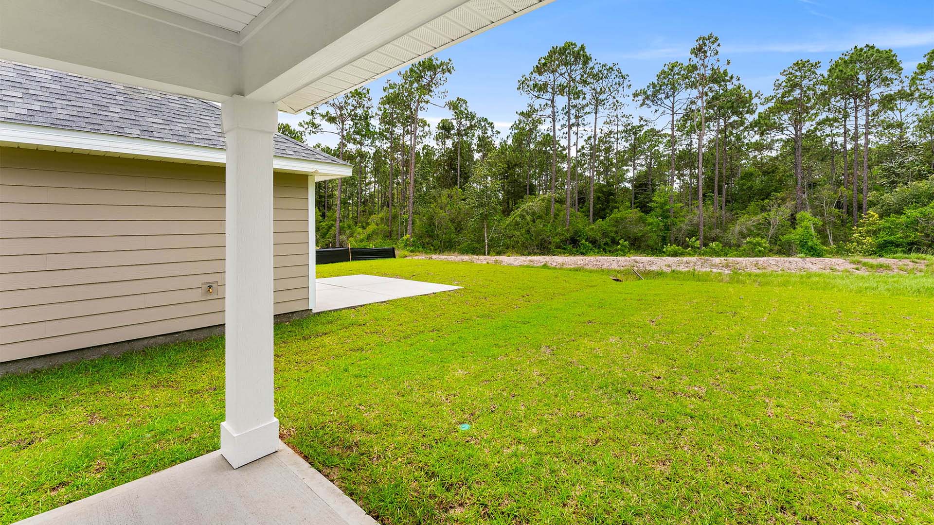 Covered rear patio view of back yard.