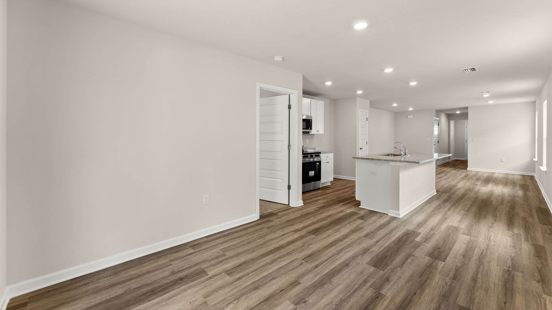 Dining area and kitchen with bedroom entrance.