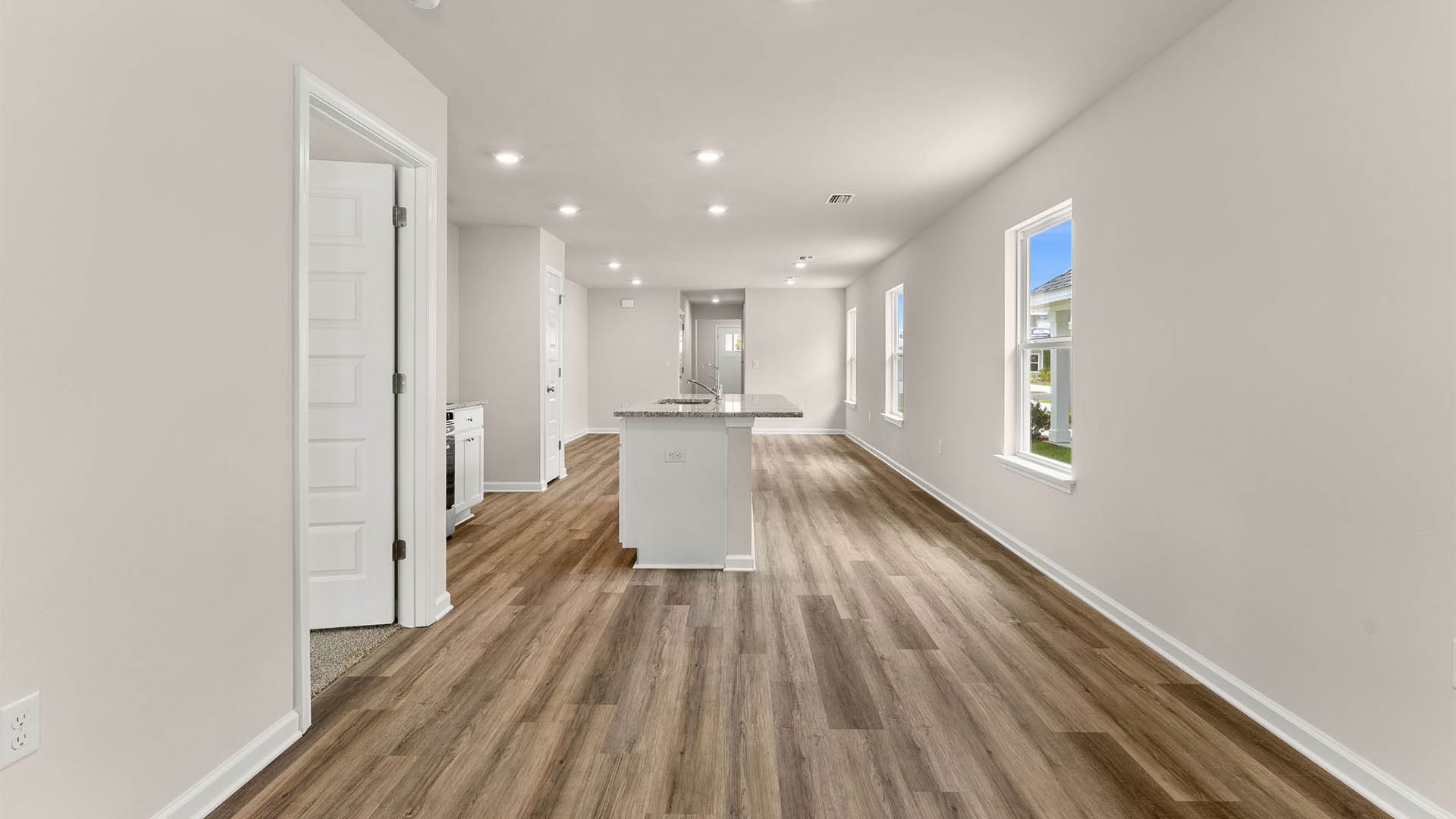 Dining area and kitchen with bedroom entrance.