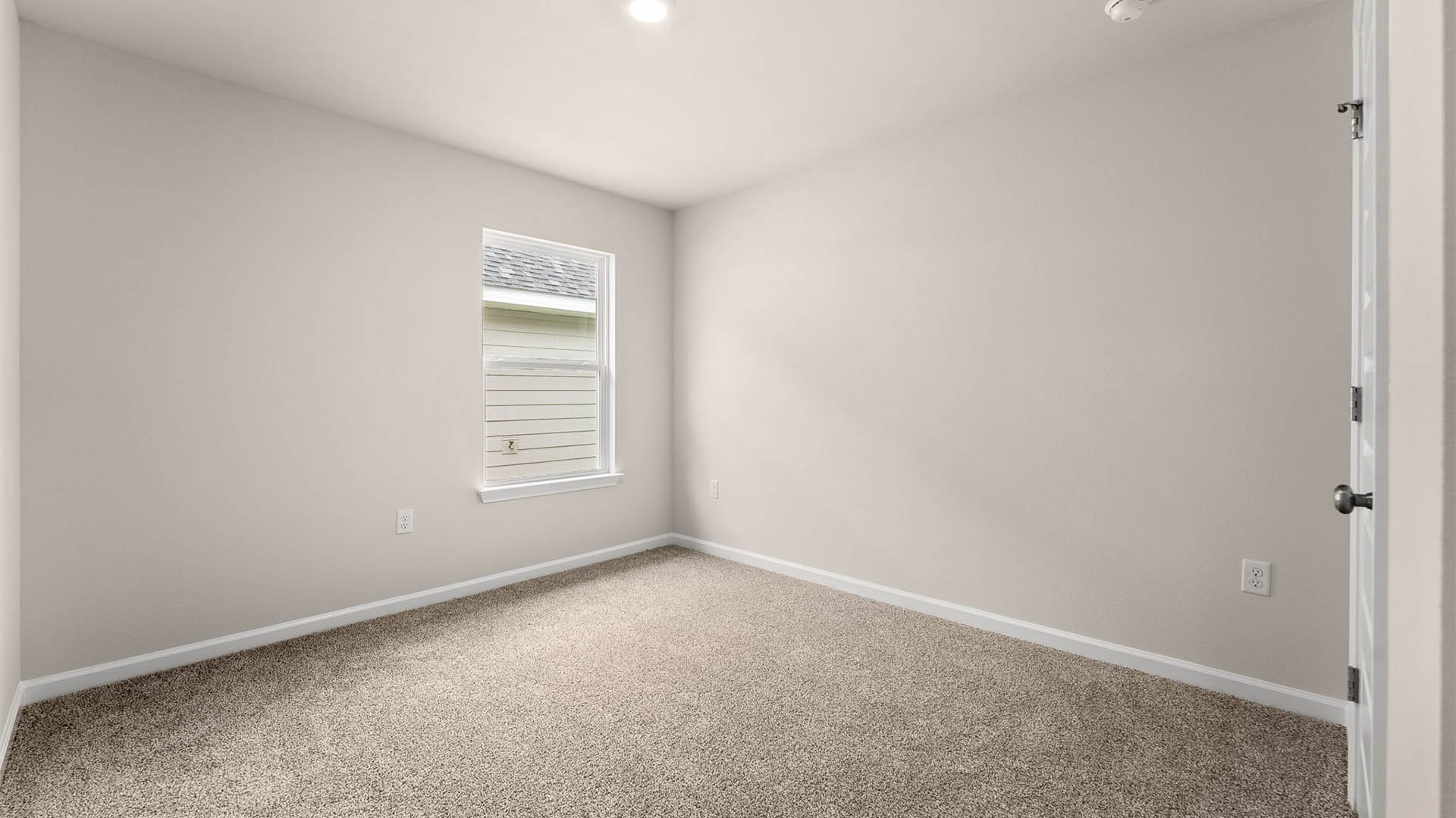 Bedroom with carpet floors and window.