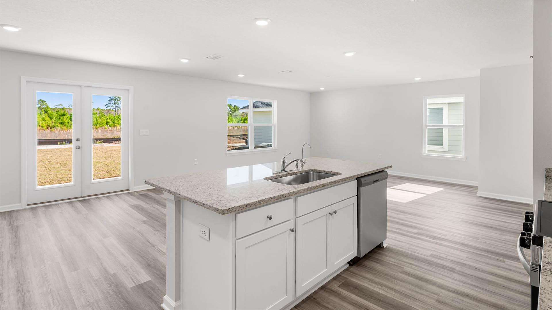 Kitchen looking into living room and back door area.