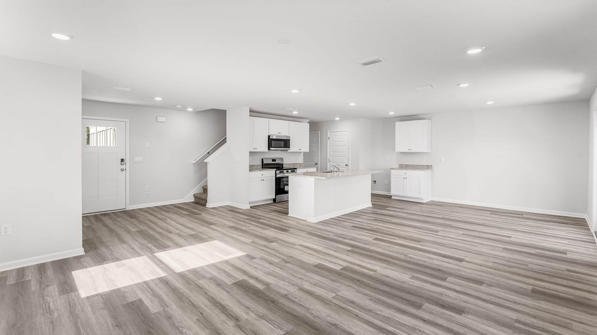 Open living room and kitchen and dining area with EVP flooring.